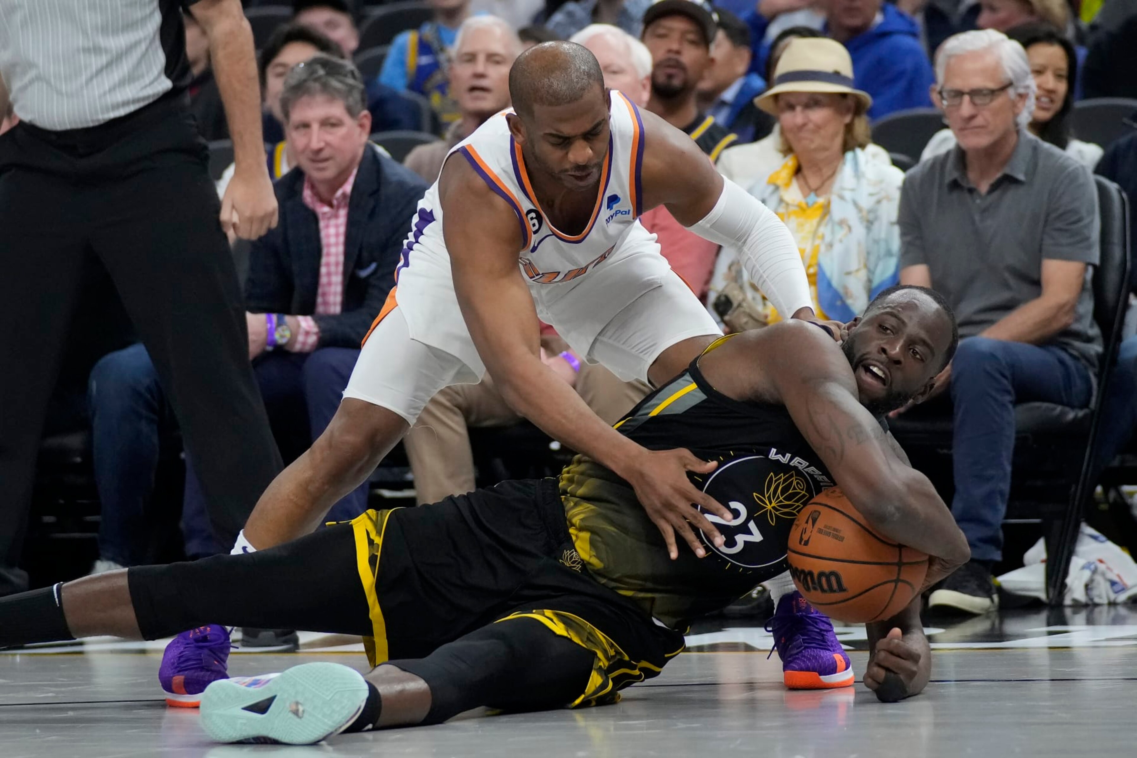 Phoenix Suns guard Chris Paul, top, reaches for the ball over Golden State Warriors forward Draymond Green during an NBA basketball game in San Francisco, Monday, March 13, 2023. (AP Photo/Jeff Chiu) Phoenix Suns guard Chris Paul, top, reaches for the ball over Golden State Warriors forward Draymond Green during an NBA basketball game in San Francisco, Monday, March 13, 2023. (AP Photo/Jeff Chiu)