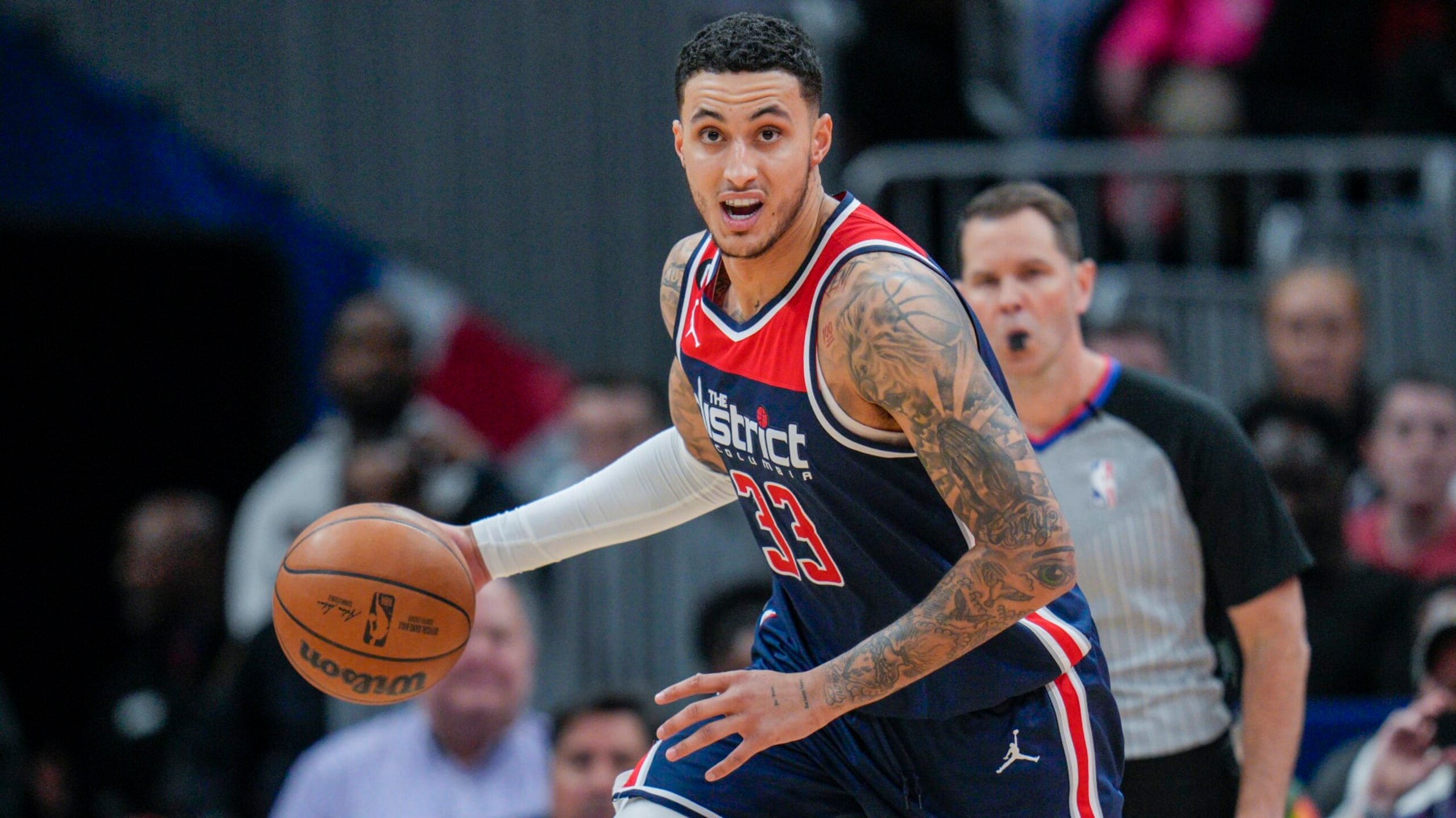 Washington Wizards forward Kyle Kuzma (33) dribbles during the first half of an NBA basketball game against the Sacramento Kings, Saturday, March 18, 2023, in Washington. (AP Photo/Jess Rapfogel)