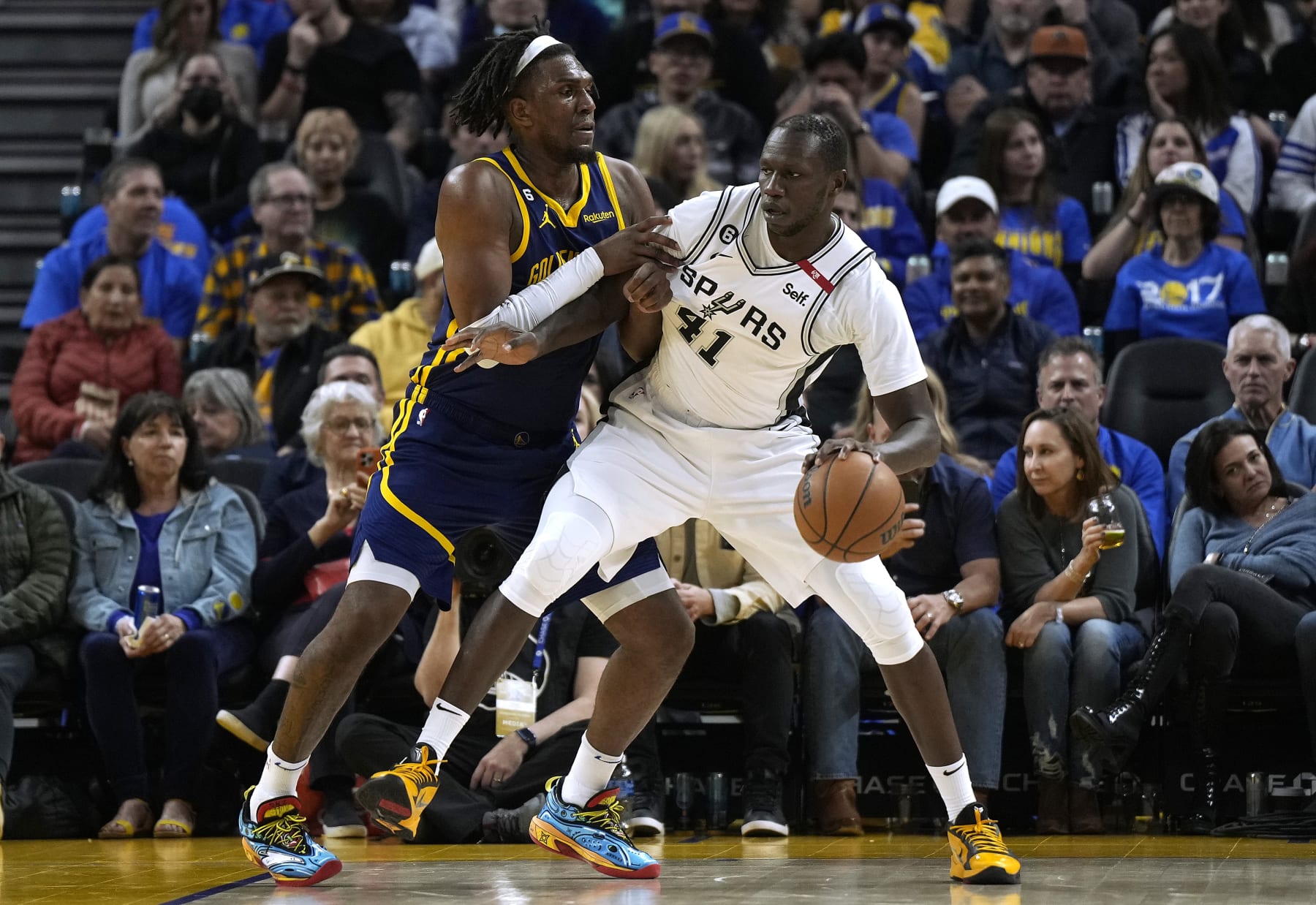 SAN FRANCISCO, CALIFORNIA - MARCH 31: Gorgui Dieng #41 of the San Antonio Spurs backs in on Kevon Looney #5 of the Golden State Warriors during the fourth quarter of an NBA basketball game at Chase Center on March 31, 2023 in San Francisco, California. NOTE TO USER: User expressly acknowledges and agrees that, by downloading and or using this photograph, User is consenting to the terms and conditions of the Getty Images License Agreement. (Photo by Thearon W. Henderson/Getty Images)