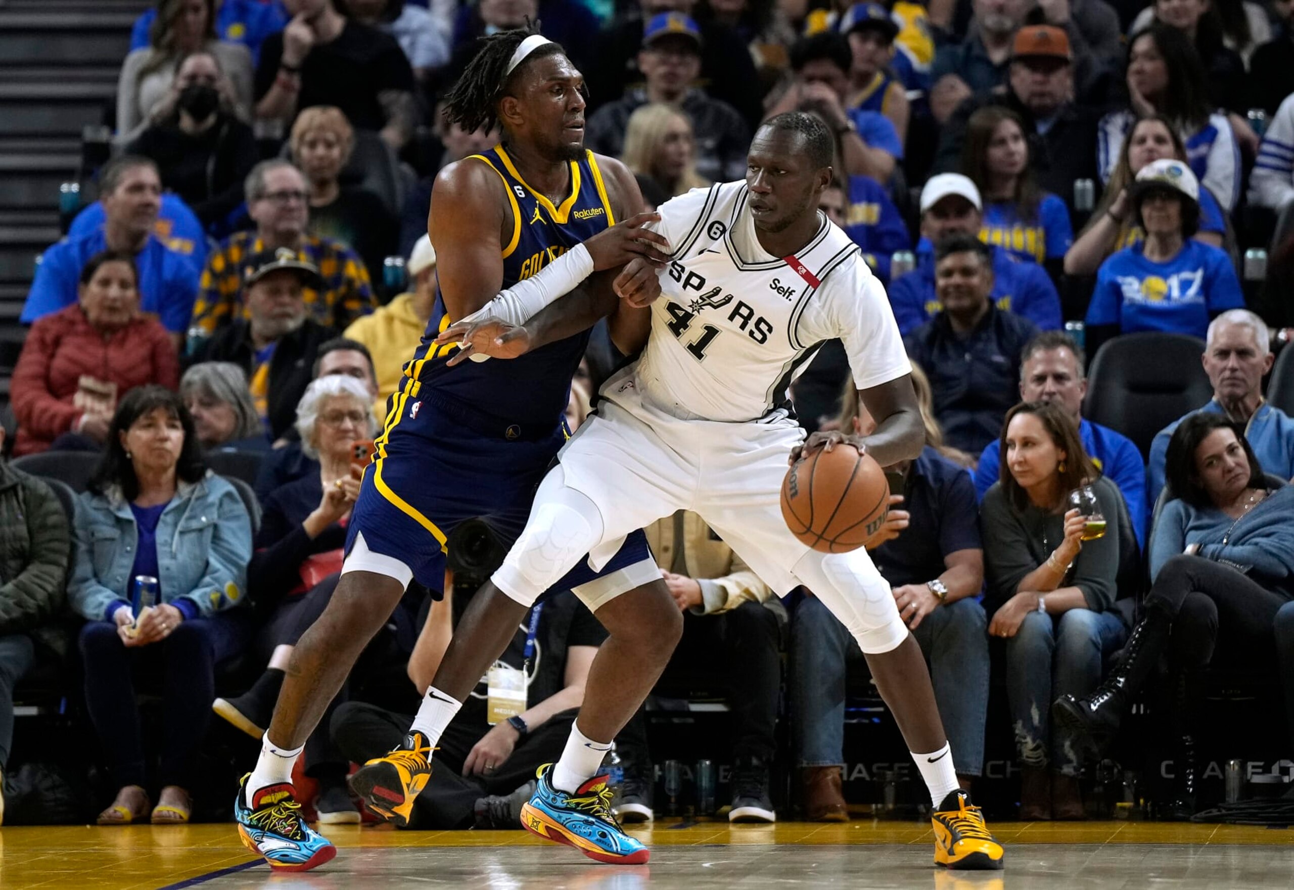 SAN FRANCISCO, CALIFORNIA - MARCH 31: Gorgui Dieng #41 of the San Antonio Spurs backs in on Kevon Looney #5 of the Golden State Warriors during the fourth quarter of an NBA basketball game at Chase Center on March 31, 2023 in San Francisco, California. NOTE TO USER: User expressly acknowledges and agrees that, by downloading and or using this photograph, User is consenting to the terms and conditions of the Getty Images License Agreement. (Photo by Thearon W. Henderson/Getty Images)