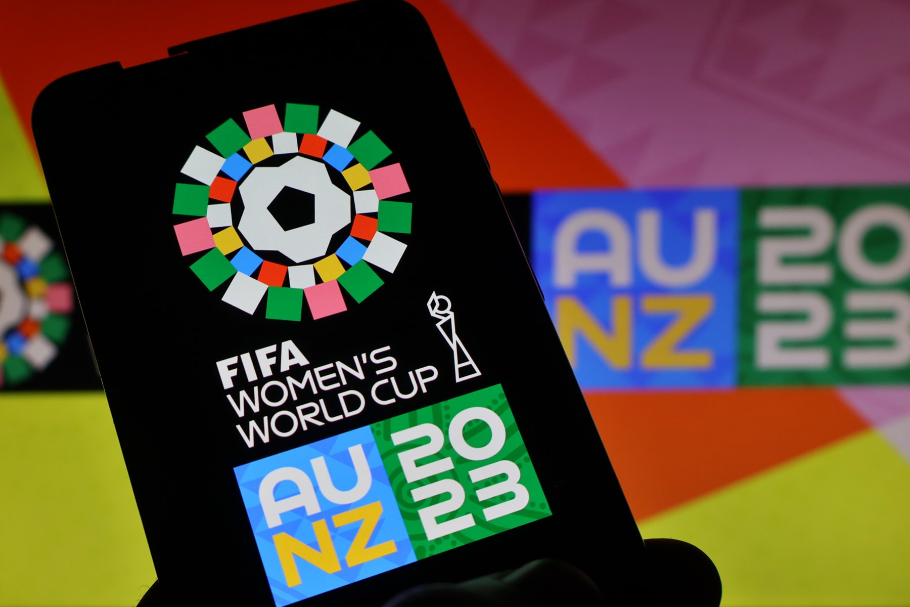 UKRAINE - 2023/07/03: In this photo illustration, a 2023 FIFA Women's World Cup logo seen displayed on a smartphone. The 2023 FIFA Women's World Cup will be the ninth edition of the FIFA Women's World Cup. The tournament will be jointly hosted by Australia and New Zealand, and is scheduled to take place from 20 July to 20 August 2023. (Photo Illustration by Aleksandr Gusev/SOPA Images/LightRocket via Getty Images)