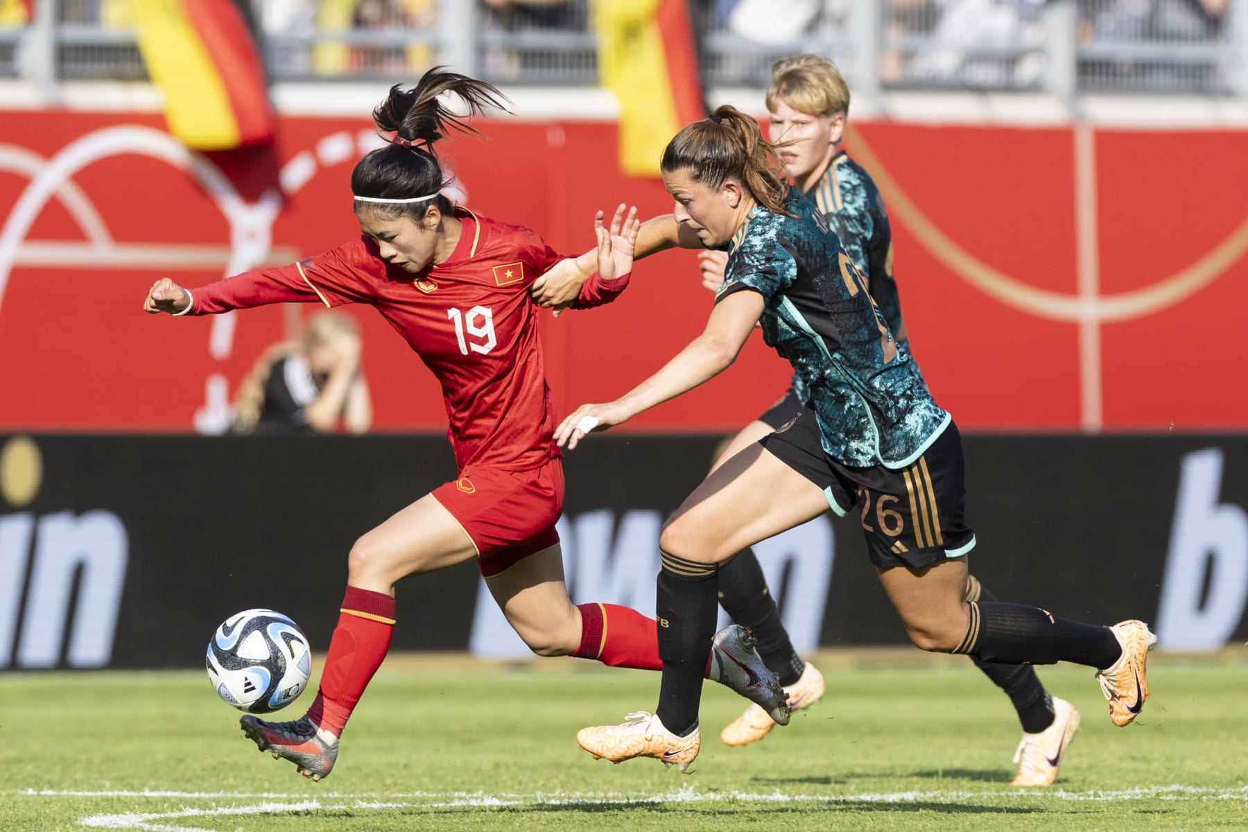 OFFENBACH, GERMANY - JUNE 24: Nha Nguyen Thi Thanh of Vietnam and Chantal Hagel of Germany battle for the ball during the Women's international friendly between Germany and Vietnam at Stadion Am Bieberer Berg on June 24, 2023 in Offenbach, Germany. (Photo by Marco Steinbrenner/DeFodi Images via Getty Images)