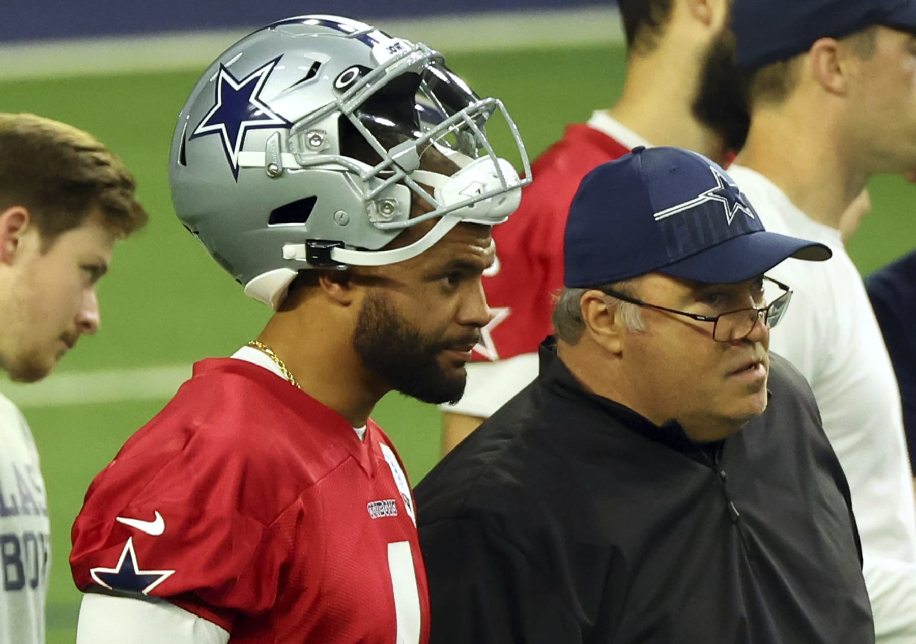 Dallas Cowboys quarterback Dak Prescott (4) and head coach Mike McCarthy talk on the field during mini camp on Tuesday, June 6, 2023, in Frisco, Texas. (AP Photo/Richard W. Rodriguez)