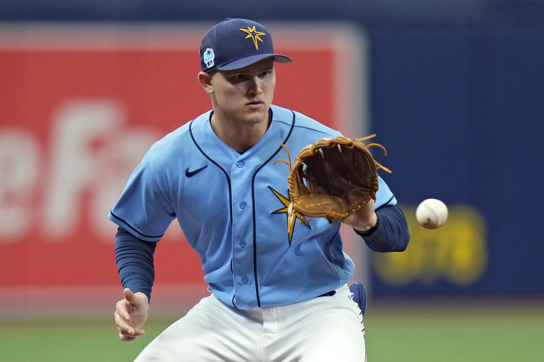 Tampa Bay Rays third baseman Curtis Mead fields a ground ball by Miami Marlins' Jerar Encarnacion and throws him out at first base during the third inning of a spring training baseball game Monday, March 6, 2023, in St. Petersburg, Fla. (AP Photo/Chris O'Meara)