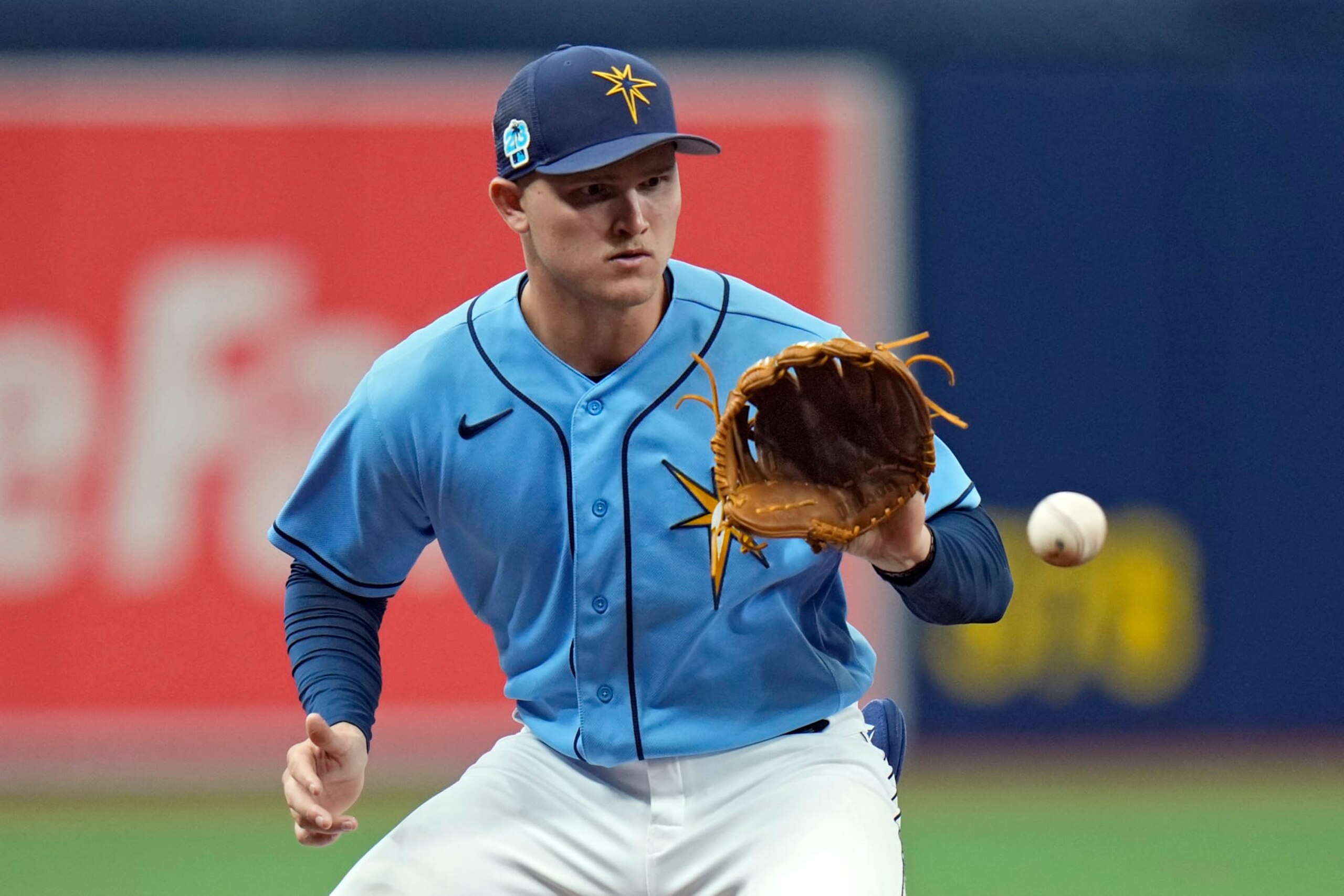 Tampa Bay Rays third baseman Curtis Mead fields a ground ball by Miami Marlins' Jerar Encarnacion and throws him out at first base during the third inning of a spring training baseball game Monday, March 6, 2023, in St. Petersburg, Fla. (AP Photo/Chris O'Meara)
