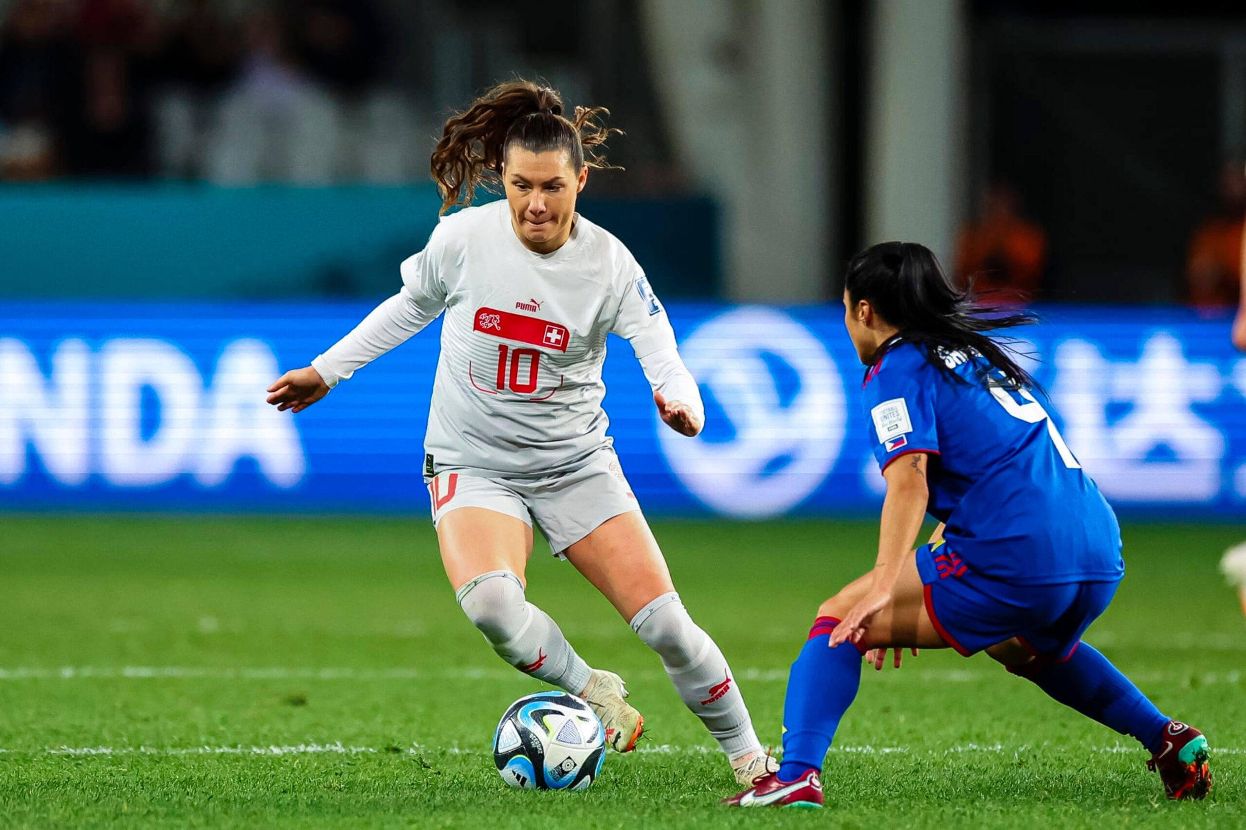 DUNEDIN, NEW ZEALAND - JULY 21: Ramona Bachmann of Switzerland (L) dribbles Isabella Flanigan of Philippines (R) during the FIFA Women's World Cup Australia & New Zealand 2023 Group A match between Philippines and Switzerland at Dunedin Stadium on July 21, 2023 in Dunedin, New Zealand. (Photo by James Whitehead/Eurasia Sport Images/Getty Images)
