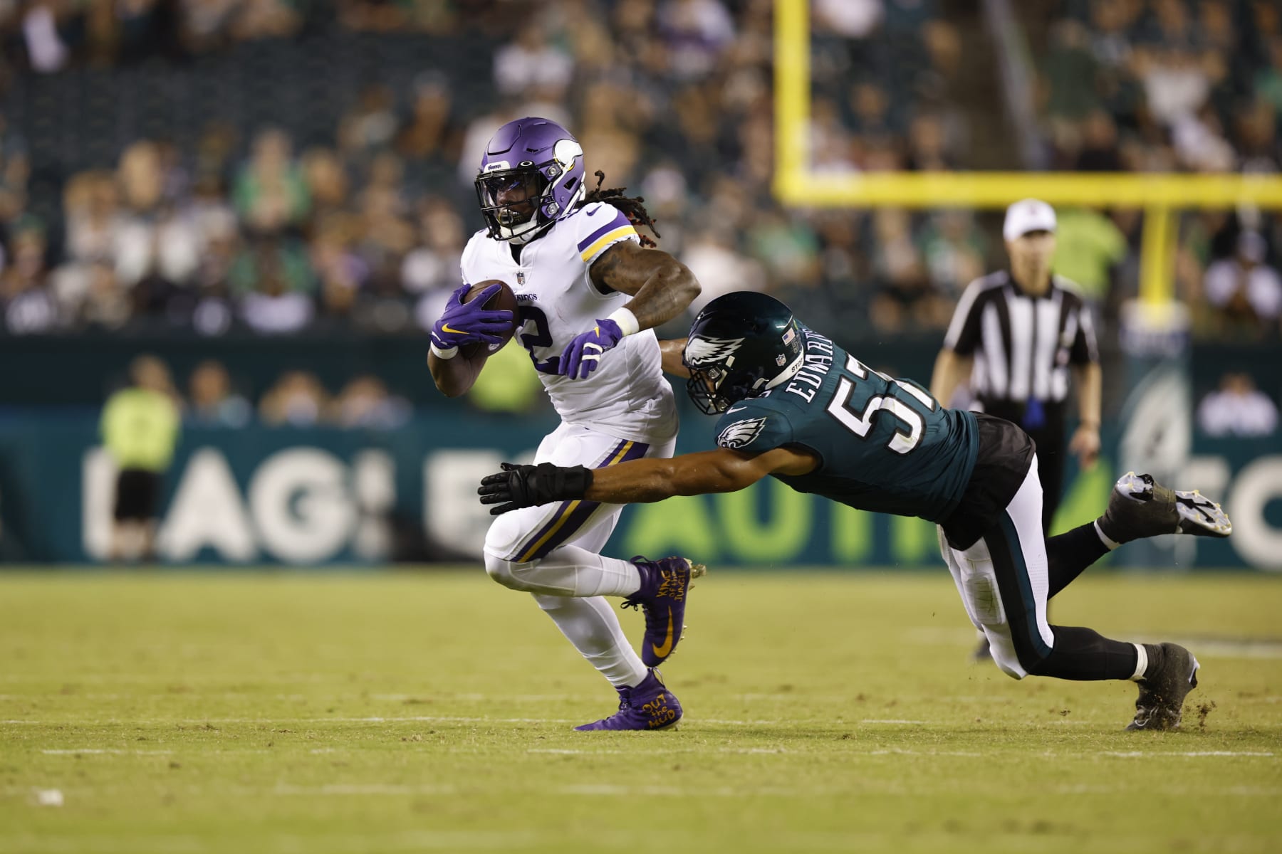 Minnesota Vikings running back Alexander Mattison (2) carries the ball as T.J. Edwards (57) makes the tackle during an NFL football game against the Philadelphia Eagles on Monday, September 19, 2022, in Philadelphia. (AP Photo/Matt Patterson)