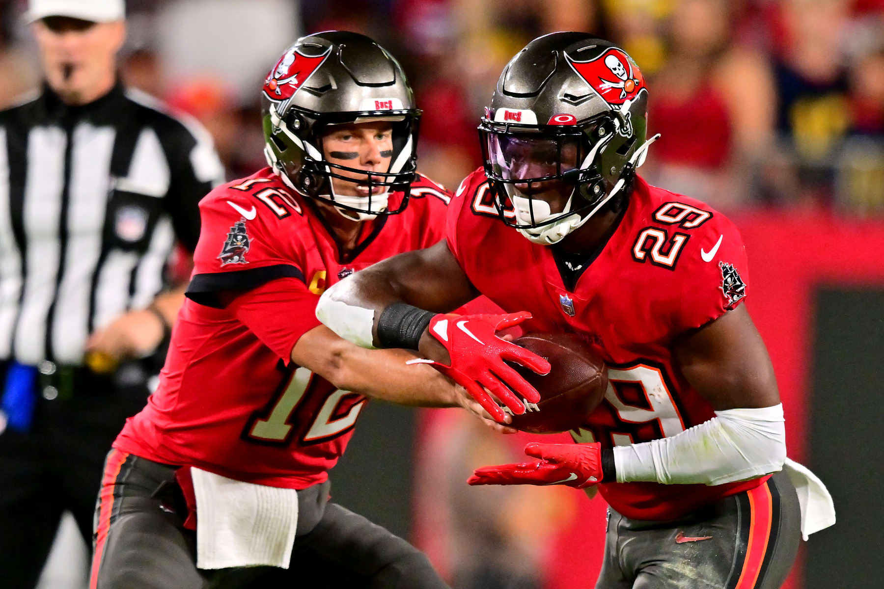 TAMPA, FLORIDA - DECEMBER 05: Tom Brady #12 of the Tampa Bay Buccaneers hands the ball off to Rachaad White #29 against the New Orleans Saints during the first quarter in the game at Raymond James Stadium on December 05, 2022 in Tampa, Florida. (Photo by Julio Aguilar/Getty Images)