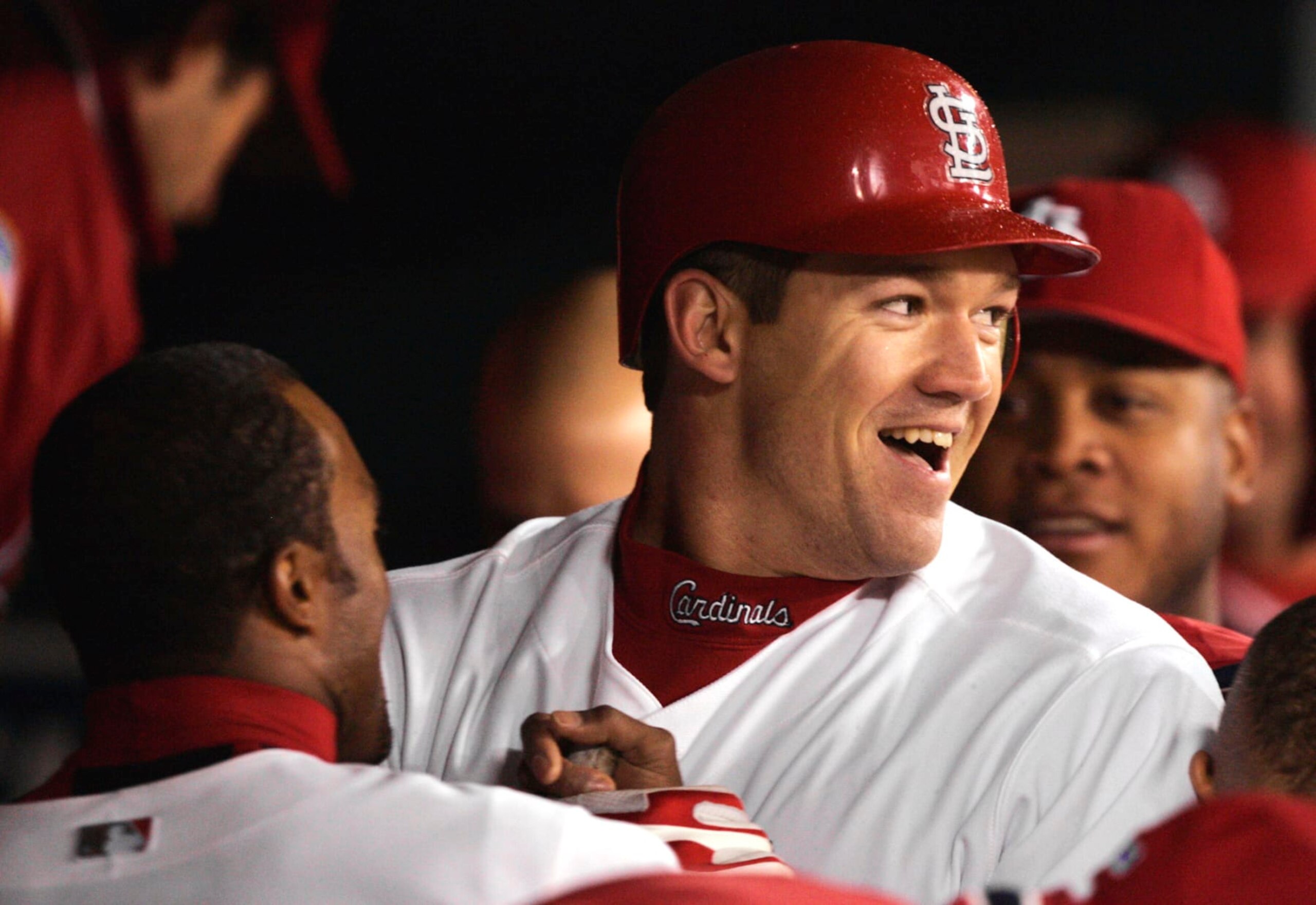 St. Louis Cardinals' Scott Rolen is welcomed to the dugout after his eighth inning solo home run against the Houston Astros in Game 2 of the National League Championship Series, Thursday, Oct. 14, 2004, in St. Louis. Rolen's homer followed teammate Albert Pujols solo shot and the Cardinals won, 6-4, to take a 2-0 lead in the series. (AP Photo/Al Behrman)