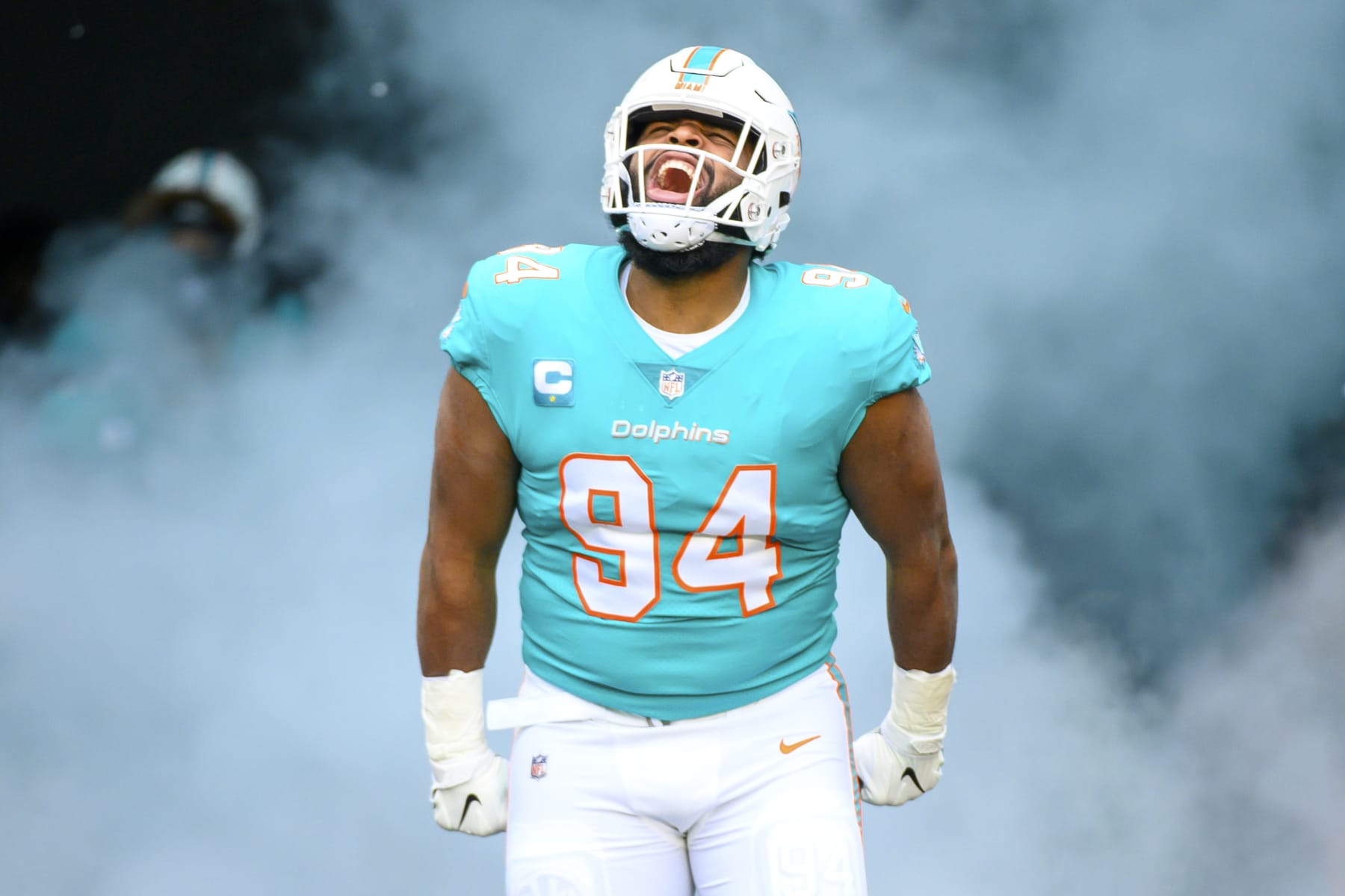 Miami Dolphins defensive tackle Christian Wilkins (94) yells as he is introduced to the fans and runs onto the field before an NFL football game against the Green Bay Packers, Sunday, Dec. 25, 2022, in Miami Gardens, Fla. (AP Photo/Doug Murray)