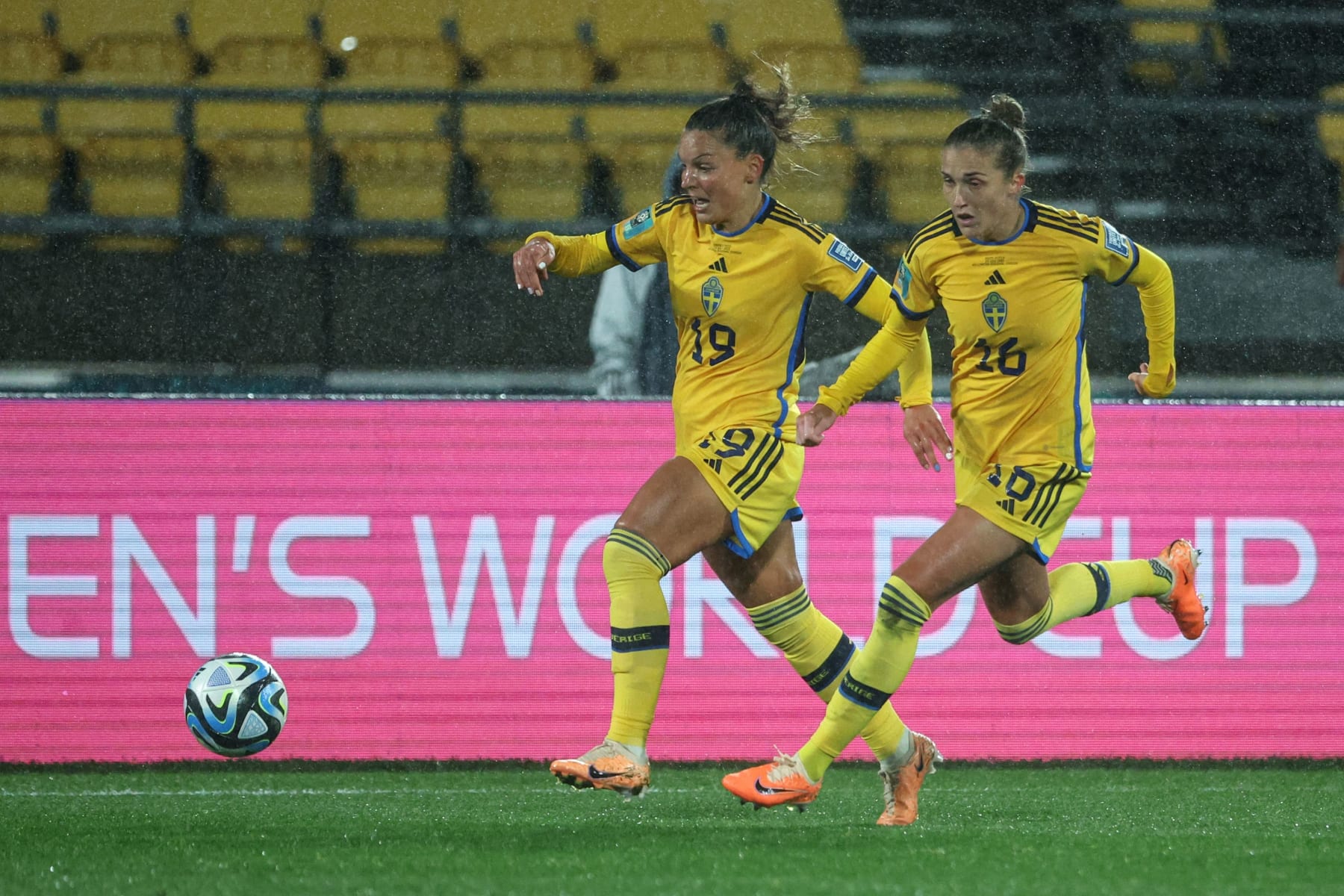 Sweden's midfielder #19 Johanna Rytting Kaneryd (C) and Sweden's midfielder #16 Filippa Angeldahl (R) run with the ball during the Australia and New Zealand 2023 Women's World Cup Group G football match between Sweden and South Africa at Wellington Stadium, also known as Sky Stadium, in Wellington on July 23, 2023. (Photo by Marty MELVILLE / AFP) (Photo by MARTY MELVILLE/AFP via Getty Images)