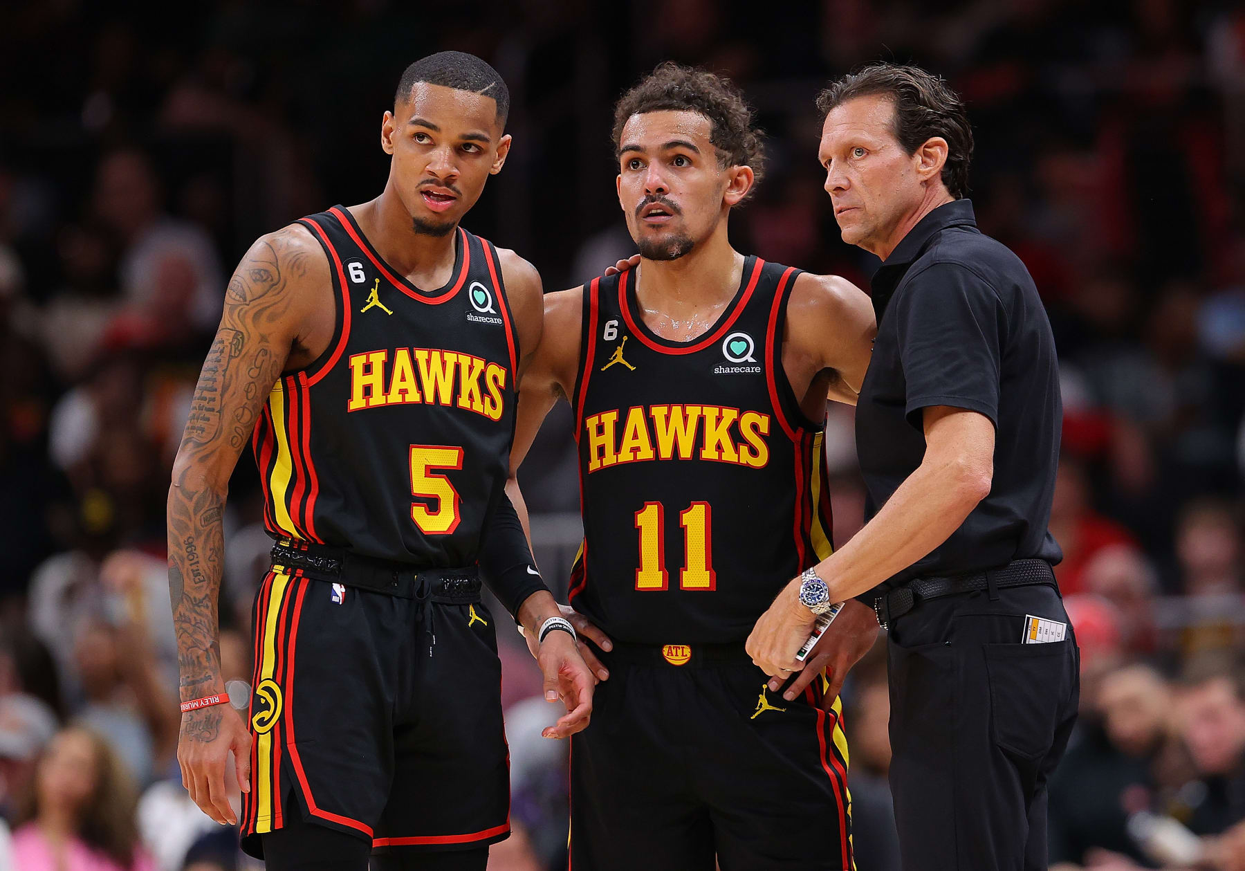 ATLANTA, GEORGIA - APRIL 21:  Head coach Quin Snyder of the Atlanta Hawks converses with Trae Young #11 and Dejounte Murray #5 against the Boston Celtics during the fourth quarter of Game Three of the Eastern Conference First Round Playoffs at State Farm Arena on April 21, 2023 in Atlanta, Georgia.  NOTE TO USER: User expressly acknowledges and agrees that, by downloading and or using this photograph, User is consenting to the terms and conditions of the Getty Images License Agreement.  (Photo by Kevin C. Cox/Getty Images)