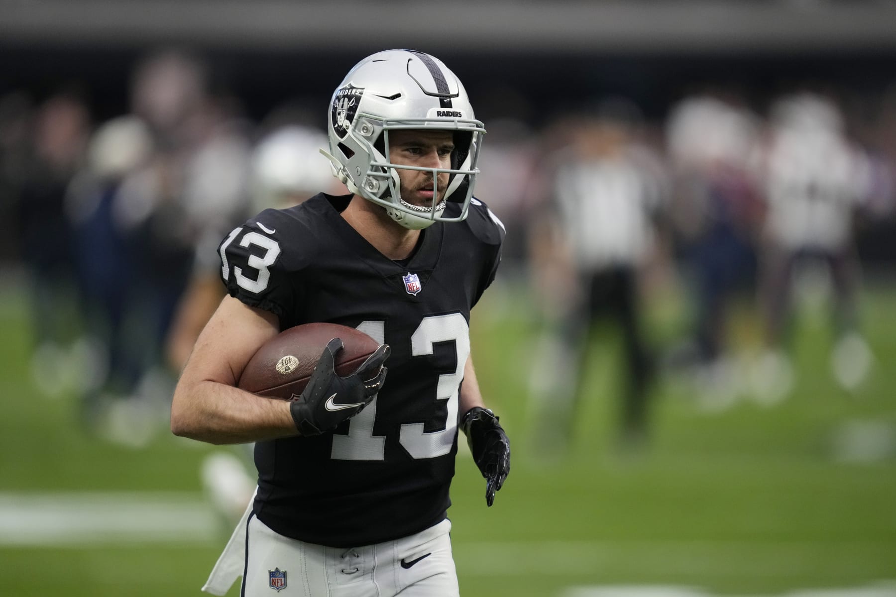 Las Vegas Raiders wide receiver Hunter Renfrow (13) warms up before an NFL football game against the New England Patriots, Monday, Dec. 19, 2022, in Las Vegas. (AP Photo/John Locher)