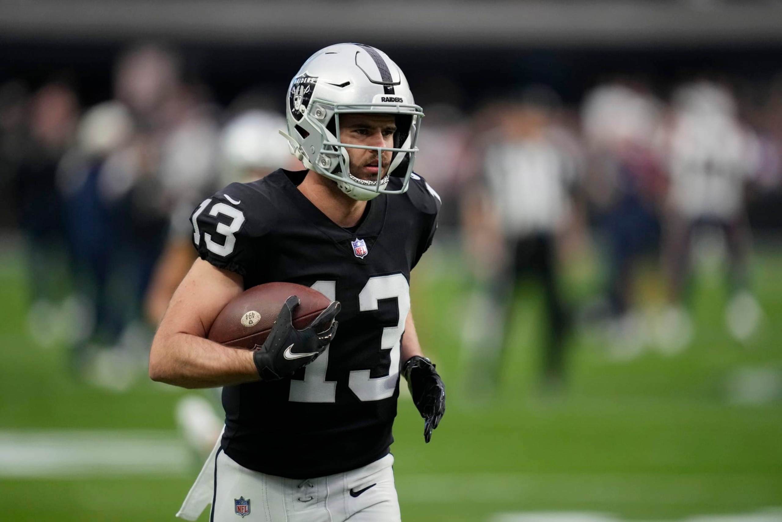 Las Vegas Raiders wide receiver Hunter Renfrow (13) warms up before an NFL football game against the New England Patriots, Monday, Dec. 19, 2022, in Las Vegas. (AP Photo/John Locher)