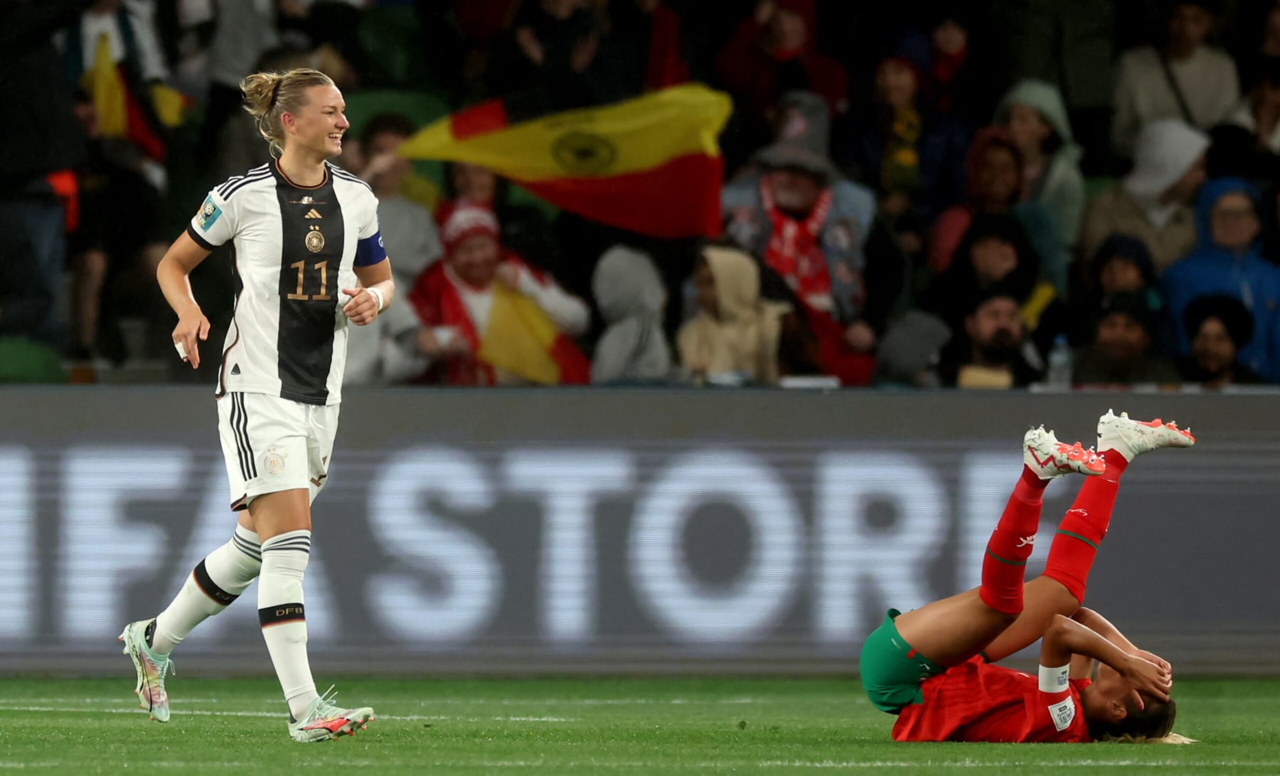 MELBOURNE, AUSTRALIA - JULY 24: Alexandra Popp of Germany celebrates her team's fourth goal while Ghizlane Chebbak of Morocco shows dejection during the FIFA Women's World Cup Australia & New Zealand 2023 Group H match between Germany and Morocco at Melbourne Rectangular Stadium on July 24, 2023 in Melbourne / Naarm, Australia. (Photo by Alex Grimm - FIFA/FIFA via Getty Images)