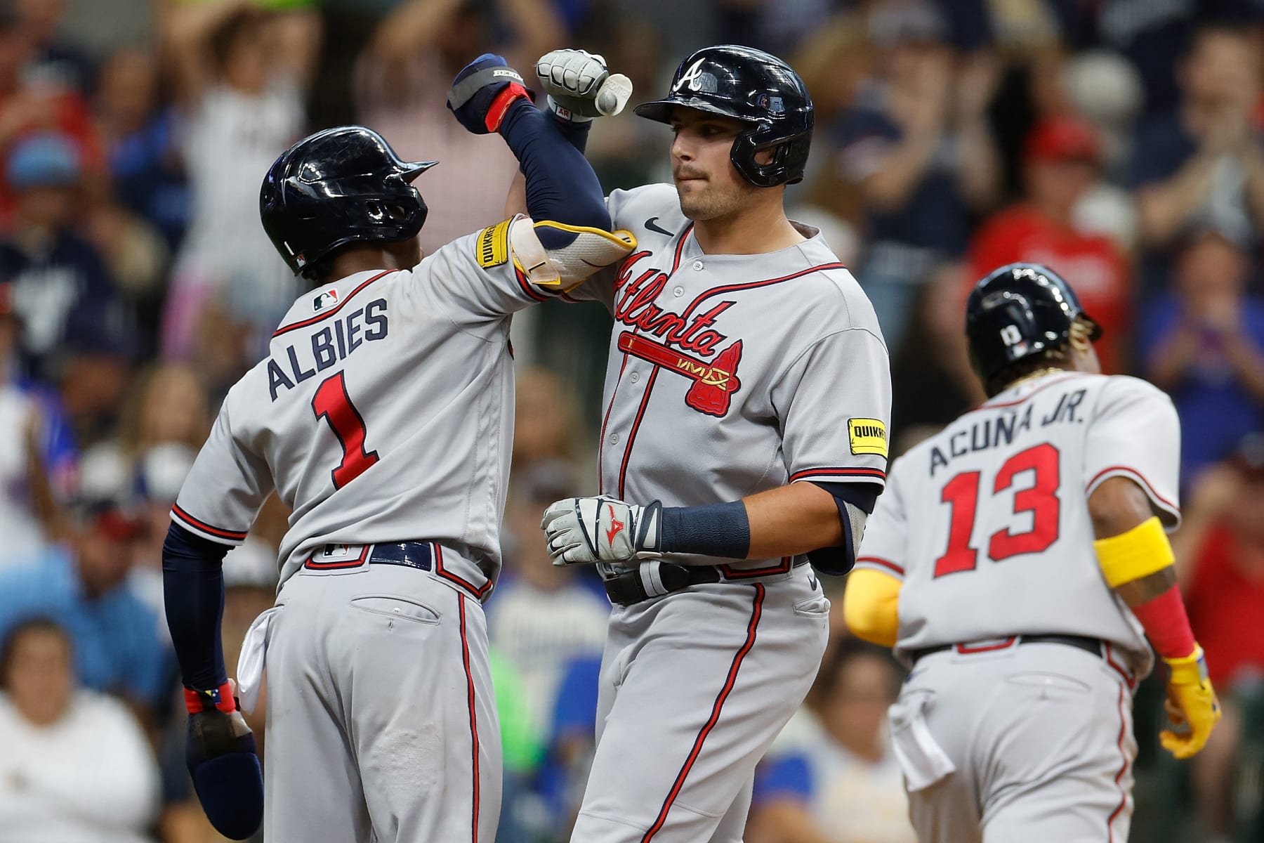 MILWAUKEE, WISCONSIN - JULY 22: Austin Riley #27 of the Atlanta Braves is congratulated by Ozzie Albies #1 after hitting a three run homer in the third inning against the Milwaukee Brewers  at American Family Field on July 22, 2023 in Milwaukee, Wisconsin. (Photo by John Fisher/Getty Images)