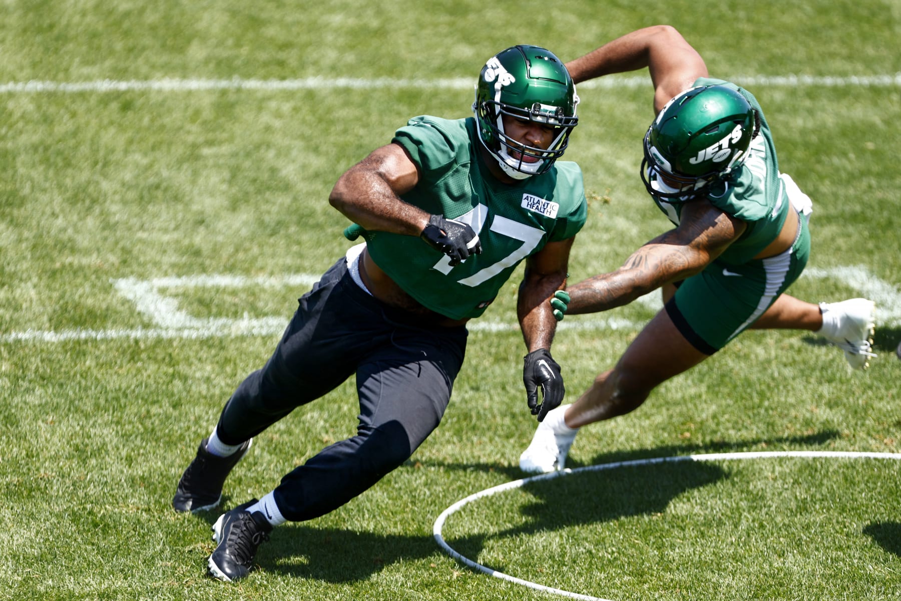 FLORHAM PARK, NEW JERSEY - MAY 31: Bryce Huff #47 and Jermaine Johnson #52 of the New York Jets run a drill during the teams OTAs at Atlantic Health Jets Training Center on May 31, 2023 in Florham Park, New Jersey. (Photo by Rich Schultz/Getty Images)