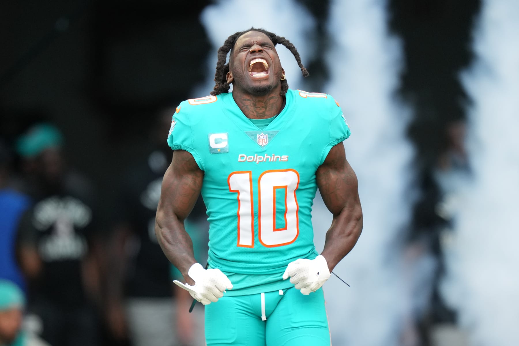 MIAMI GARDENS, FL - JANUARY 08: Miami Dolphins wide receiver Tyreek Hill (10) tries to excite the crowd during pregame introductions before the game between the New York Jets and the Miami Dolphins on Sunday, January 8, 2023 at Hard Rock Stadium, Miami Gardens, Fla. (Photo by Peter Joneleit/Icon Sportswire via Getty Images)