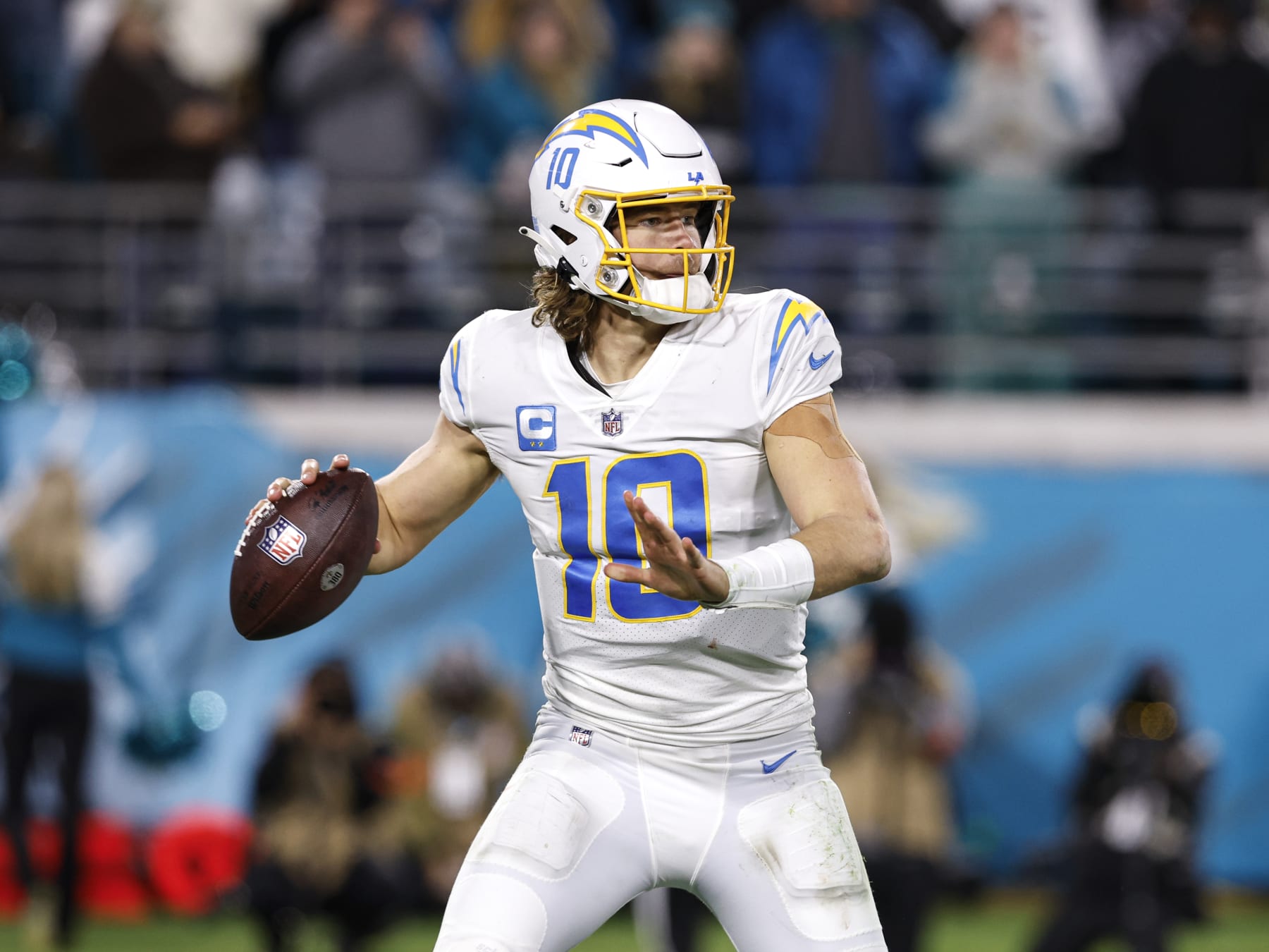JACKSONVILLE, FL - JANUARY 14: Quarterback Justin Herbert #10 of the Los Angeles Chargers on a pass play during the AFC Wild Card Playoffs game against the Jacksonville Jaguars at TIAA Bank Field on January 14, 2023 in Jacksonville, Florida. The Jaguars defeated the Chargers 31 to 30. (Photo by Don Juan Moore/Getty Images)