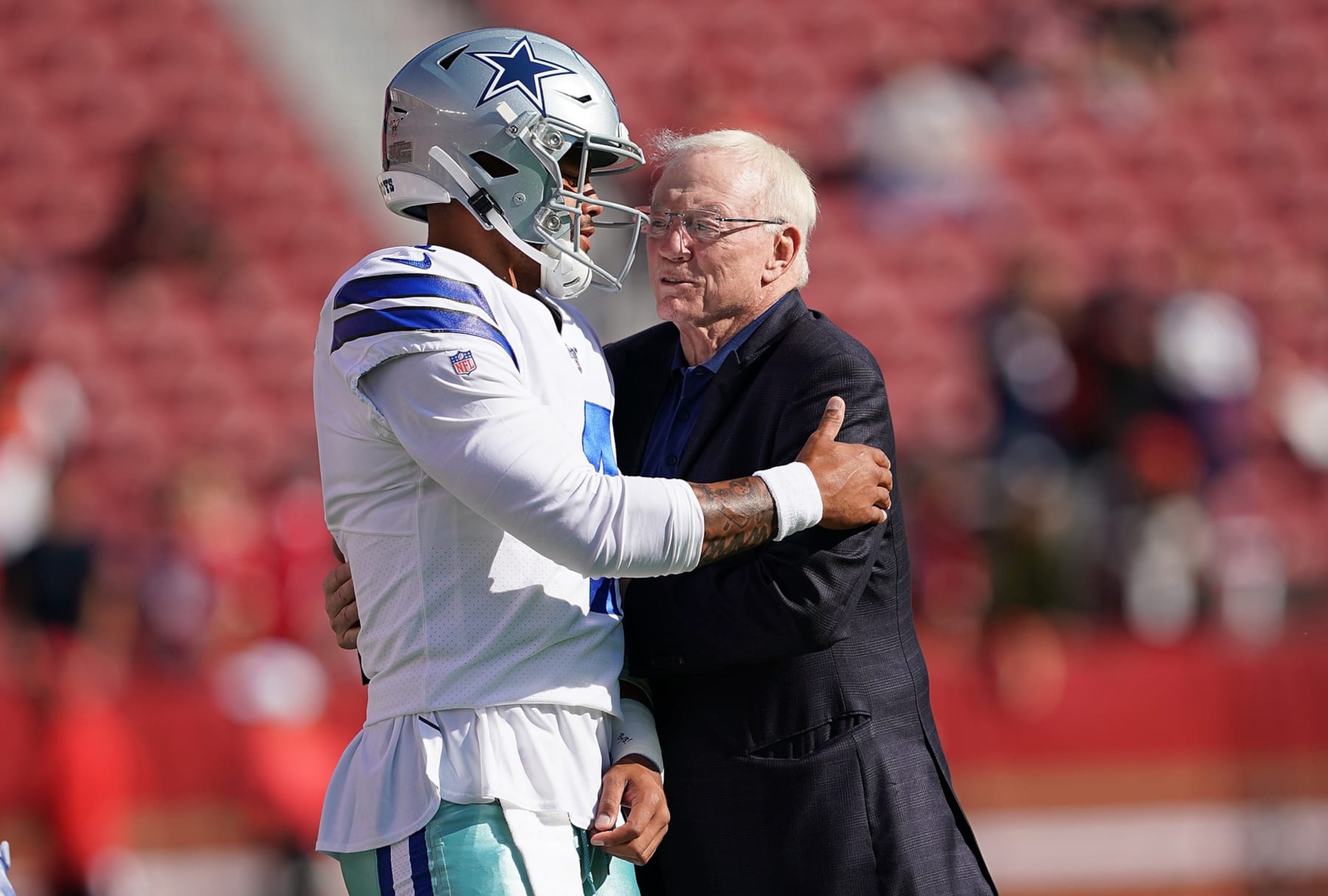 SANTA CLARA, CA - AUGUST 10: Quarterback Dak Prescott #4 and team owner Jerry Jones of the Dallas Cowboys hug each other during pregame warm ups prior to the start of an NFL preseason football game against the San Francisco 49ers at Levi's Stadium on August 10, 2019 in Santa Clara, California. (Photo by Thearon W. Henderson/Getty Images) SANTA CLARA, CA - AUGUST 10: Quarterback Dak Prescott #4 and team owner Jerry Jones of the Dallas Cowboys hug each other during pregame warm ups prior to the start of an NFL preseason football game against the San Francisco 49ers at Levi's Stadium on August 10, 2019 in Santa Clara, California. (Photo by Thearon W. Henderson/Getty Images)