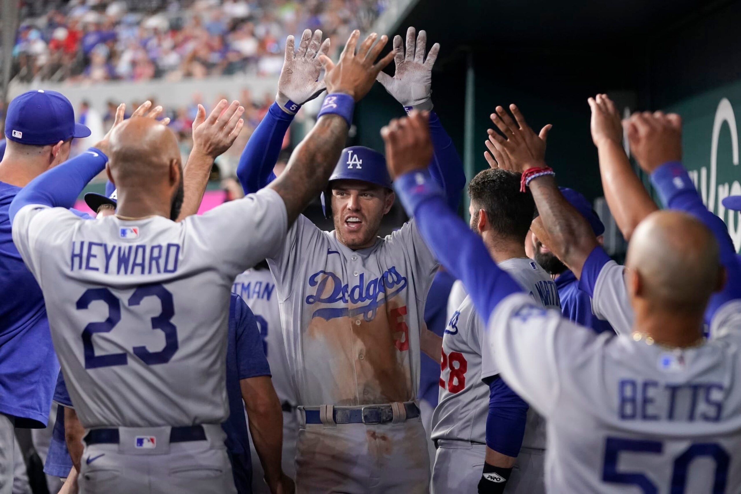 ARLINGTON, TEXAS - JULY 22: Freddie Freeman #5 of the Los Angeles Dodgers celebrates in his dugout after hitting a two-run home run during the fourth inning against the Texas Rangers at Globe Life Field on July 22, 2023 in Arlington, Texas. (Photo by Sam Hodde/Getty Images)