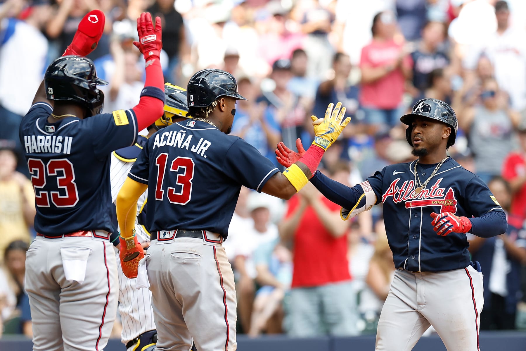 MILWAUKEE, WISCONSIN - JULY 23: Ozzie Albies #1 of the Atlanta Braves is congratulated by Ronald Acuna Jr. #13 and Michael Harris II #23 after hitting a three run homer against the Milwaukee Brewers at American Family Field on July 23, 2023 in Milwaukee, Wisconsin. (Photo by John Fisher/Getty Images)