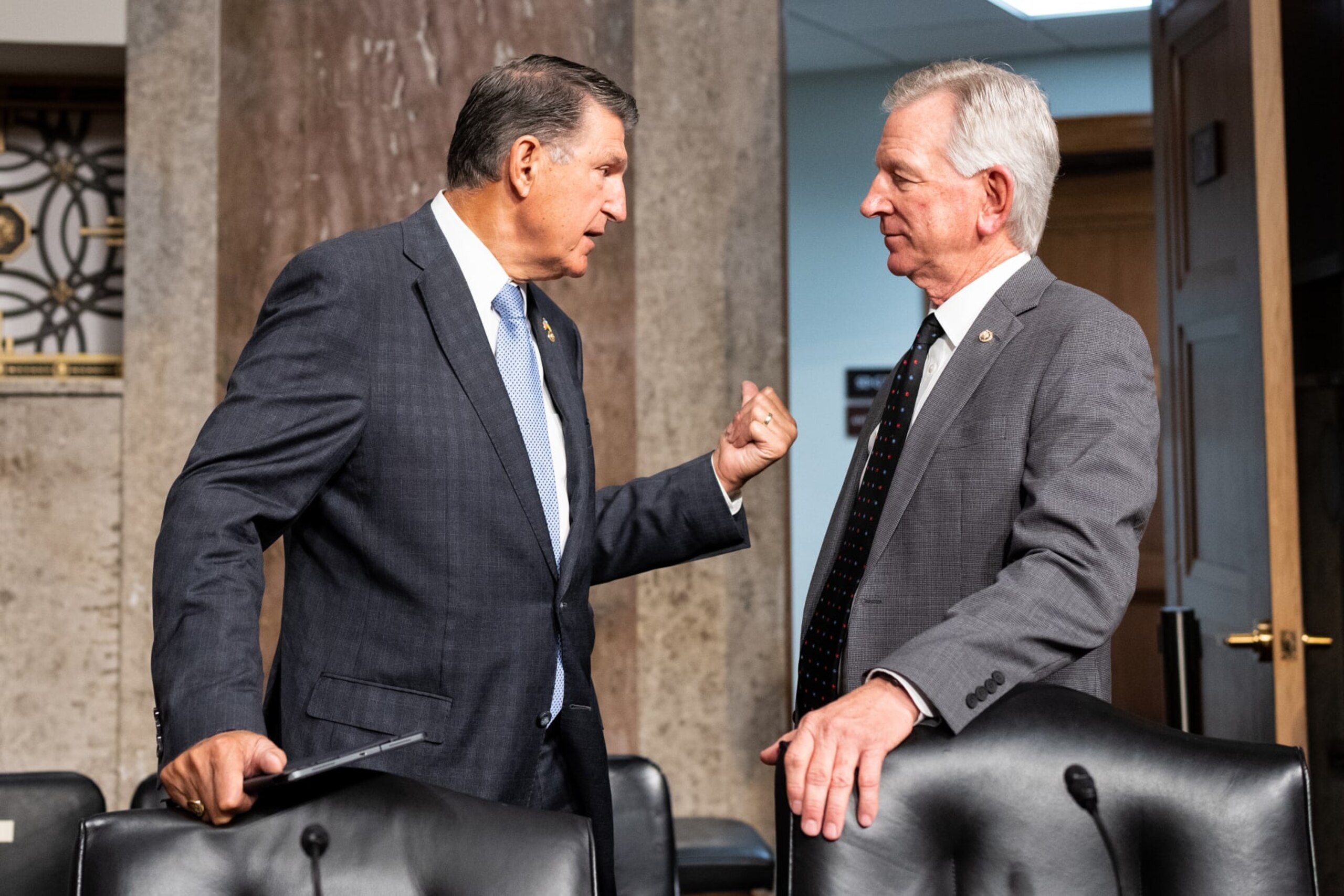 WASHINGTON - JULY 11: Sen. Joe Manchin, D-W. Va., left, and Sen. Tommy Tuberville, R-Ala., talk before the start of the confirmation hearing for Chairman of the Joint Chiefs of Staff nominee General Charles Brown Jr., in the Senate Armed Services Committee on Tuesday, July 11, 2023. (Bill Clark/CQ-Roll Call, Inc via Getty Images)