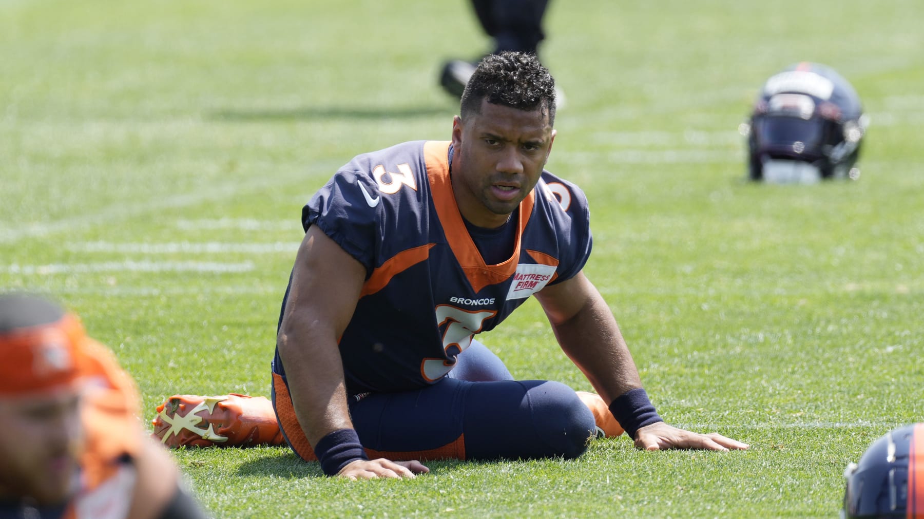 Denver Broncos quarterback Russell Wilson stretches during NFL football practice, Wednesday, June 14, 2023, in Centennial, Colo. (AP Photo/David Zalubowski)