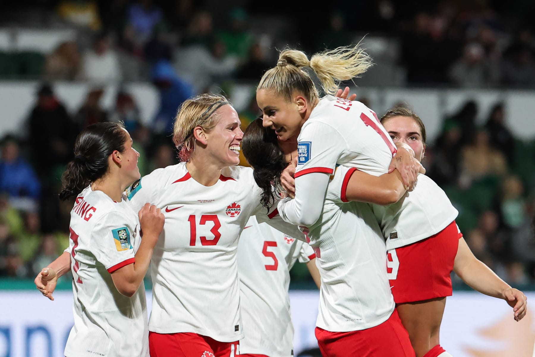 Canada's forward #19 Adriana Leon (R) celebrates with her teammates after scoring her team's second goal during the Australia and New Zealand 2023 Women's World Cup Group B football match between Canada and Ireland at Perth Rectangular Stadium in Perth on July 26, 2023. (Photo by Colin MURTY / AFP) (Photo by COLIN MURTY/AFP via Getty Images)