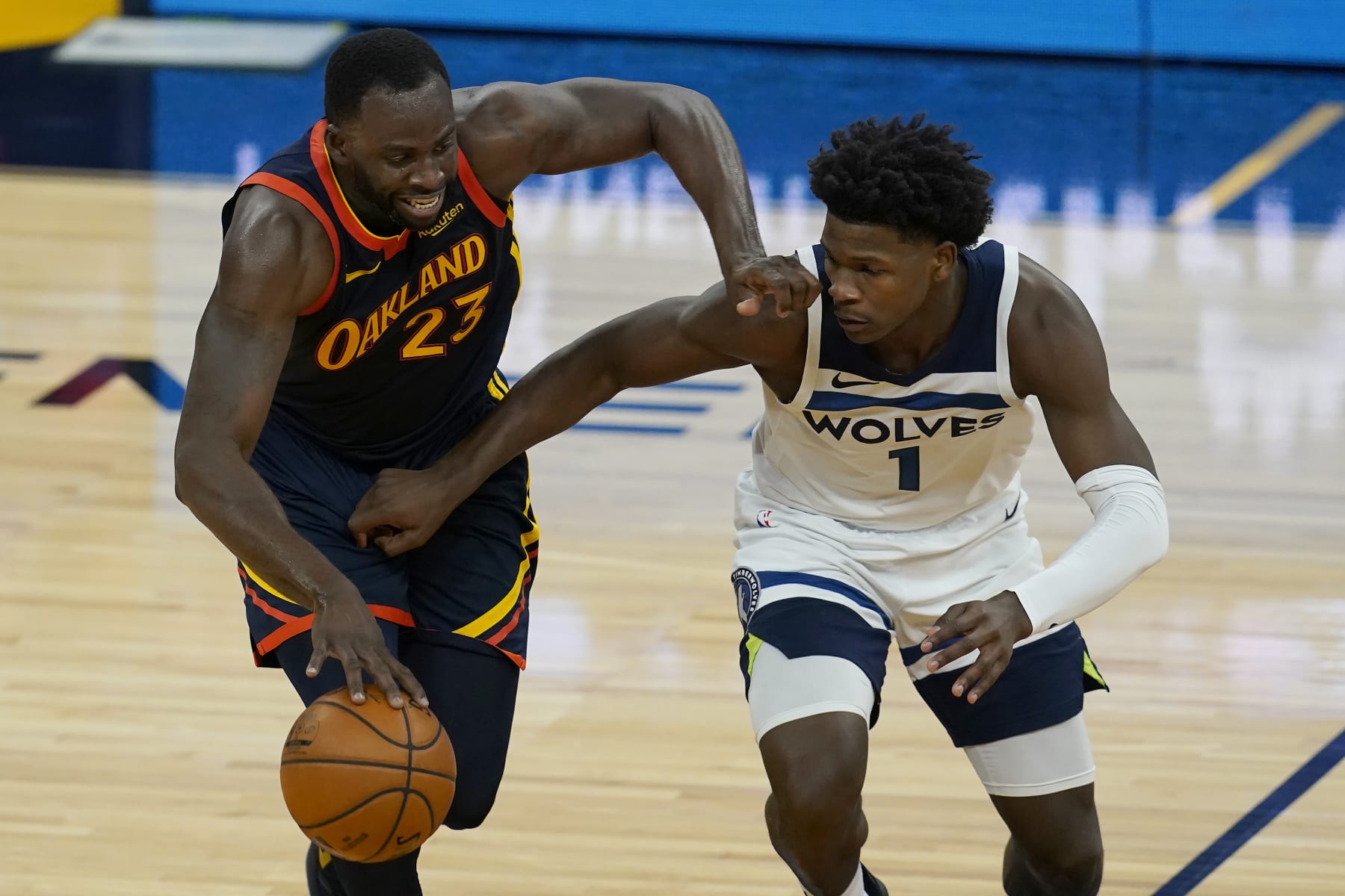 Golden State Warriors forward Draymond Green, left, is defended by Minnesota Timberwolves guard Anthony Edwards during the second half of an NBA basketball game in San Francisco, Monday, Jan. 25, 2021. (AP Photo/Jeff Chiu)