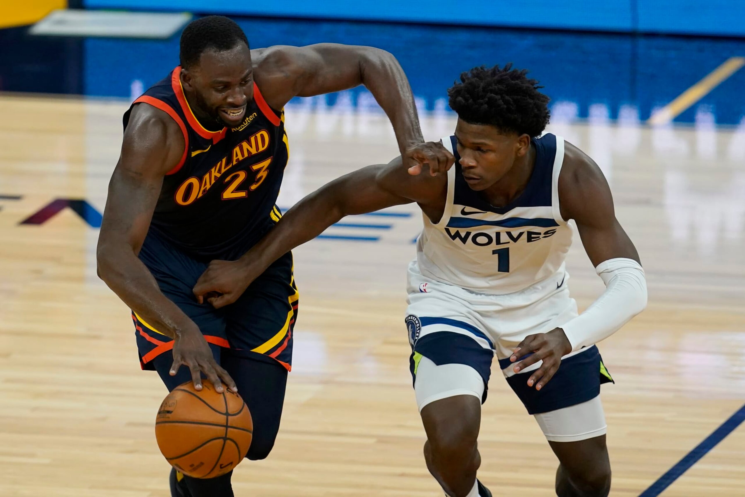 Golden State Warriors forward Draymond Green, left, is defended by Minnesota Timberwolves guard Anthony Edwards during the second half of an NBA basketball game in San Francisco, Monday, Jan. 25, 2021. (AP Photo/Jeff Chiu)