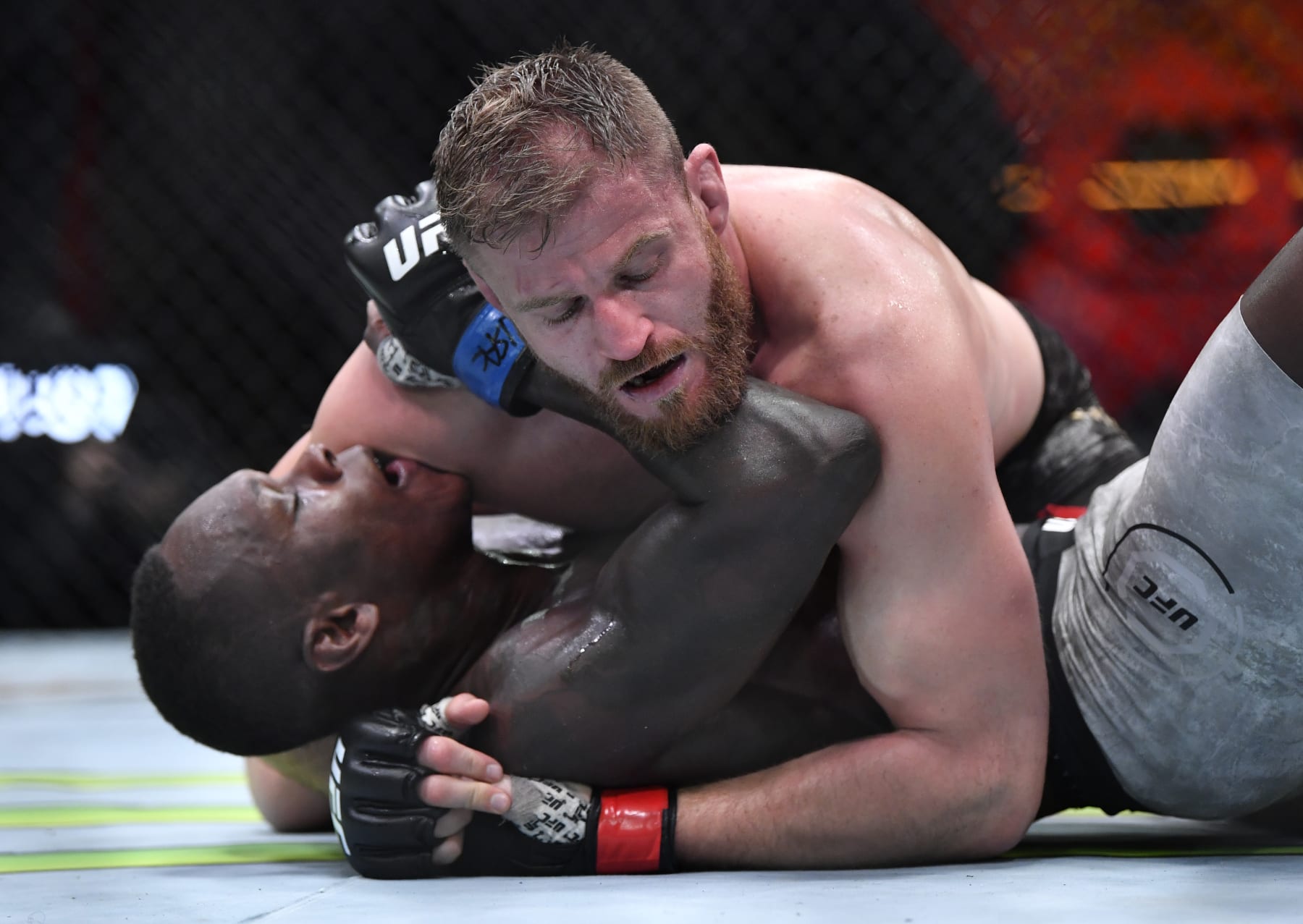 Jan Blachowicz (top) grapples Israel Adesanya.