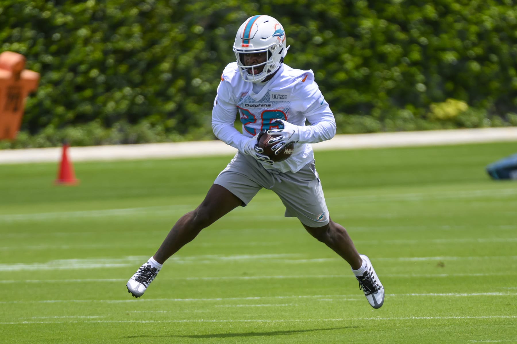 MIAMI GARDENS, FL - MAY 12: Miami Dolphins running back Devon Achane (28) runs with the ball on the field during the rookie minicamp at the Baptist Health Training Complex on May 12, 2023 in Miami Gardens, Florida. (Photo by Doug Murray/Icon Sportswire via Getty Images)