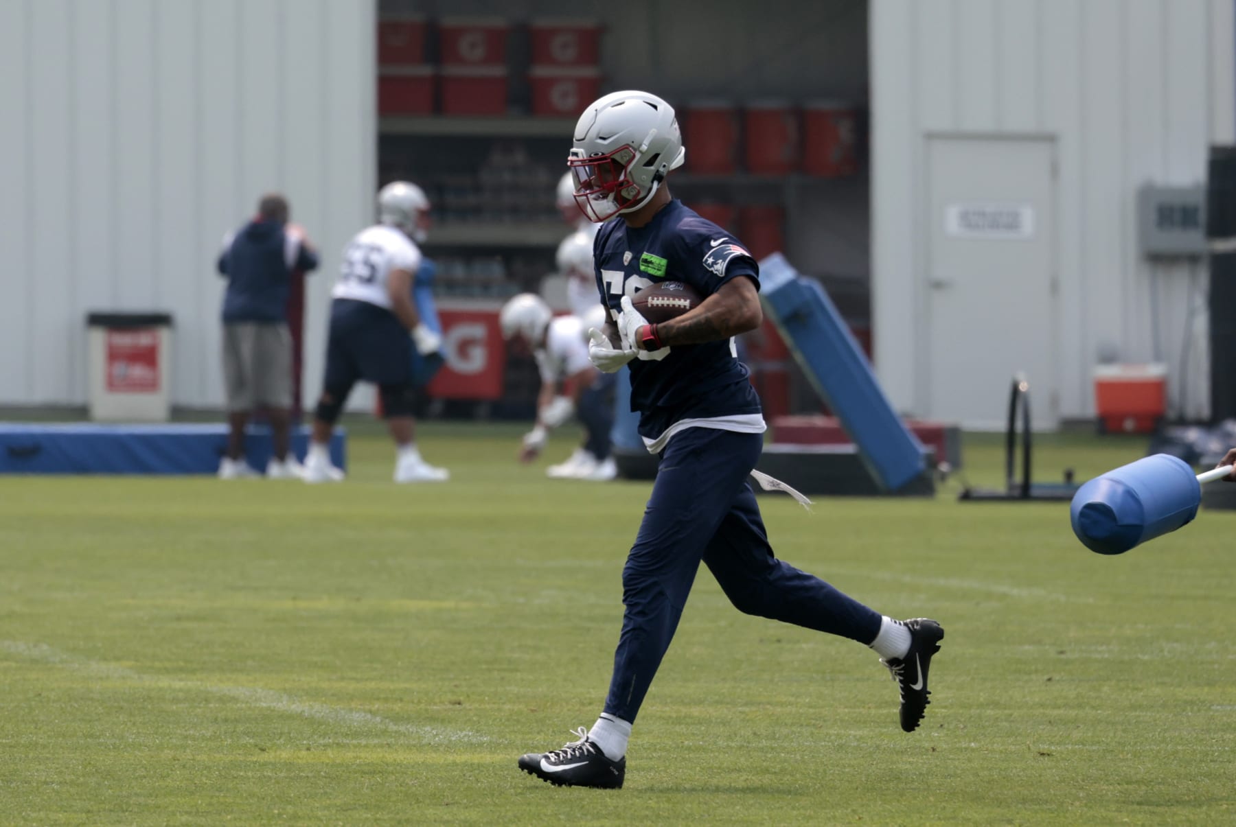 FOXBOROUGH, MA - JUNE 06: New England Patriots cornerback Christian Gonzalez (50) carries the ball during New England Patriots Optional Training Activities on June 6, 2023, at the Patriots Training Facility at Gillette Stadium in Foxborough, Massachusetts.  (Photo by Fred Kfoury III/Icon Sportswire via Getty Images)