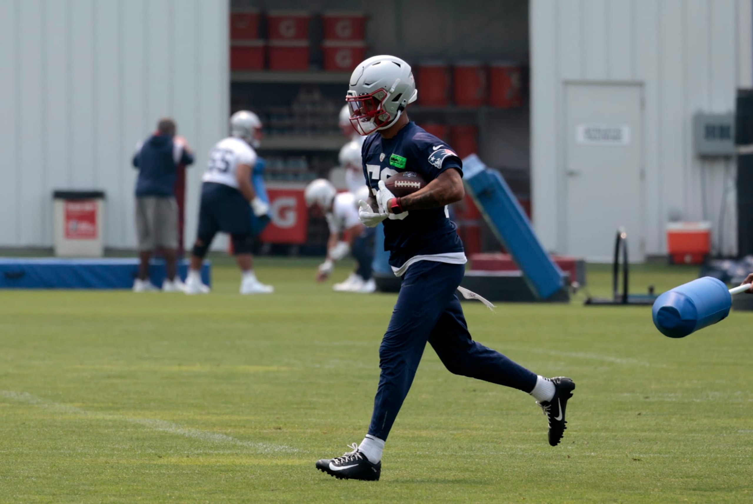 FOXBOROUGH, MA - JUNE 06: New England Patriots cornerback Christian Gonzalez (50) carries the ball during New England Patriots Optional Training Activities on June 6, 2023, at the Patriots Training Facility at Gillette Stadium in Foxborough, Massachusetts.  (Photo by Fred Kfoury III/Icon Sportswire via Getty Images)
