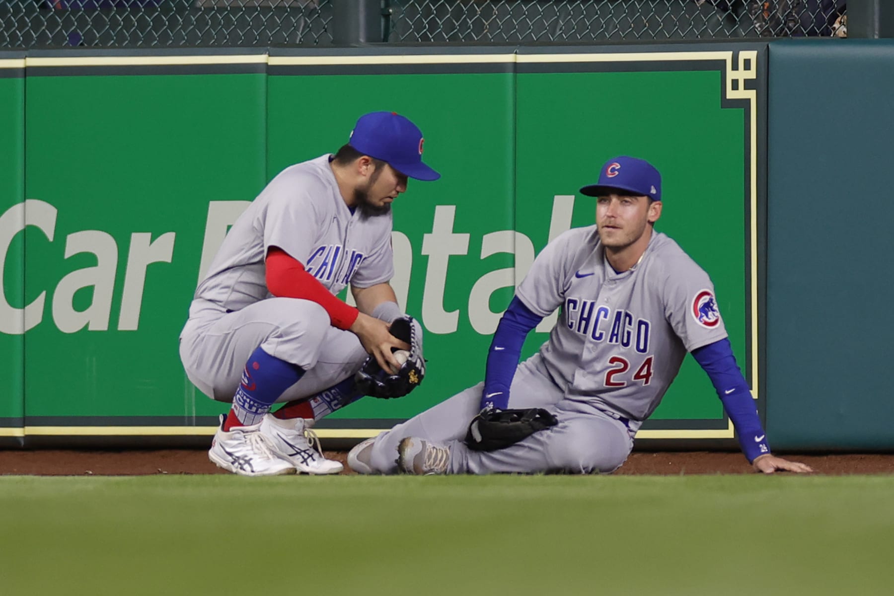 HOUSTON, TEXAS - MAY 15: Cody Bellinger #24 of the Chicago Cubs is joined by Seiya Suzuki #27  after being injured on a catch during the seventh inning against the Houston Astros at Minute Maid Park on May 15, 2023 in Houston, Texas. (Photo by Carmen Mandato/Getty Images)