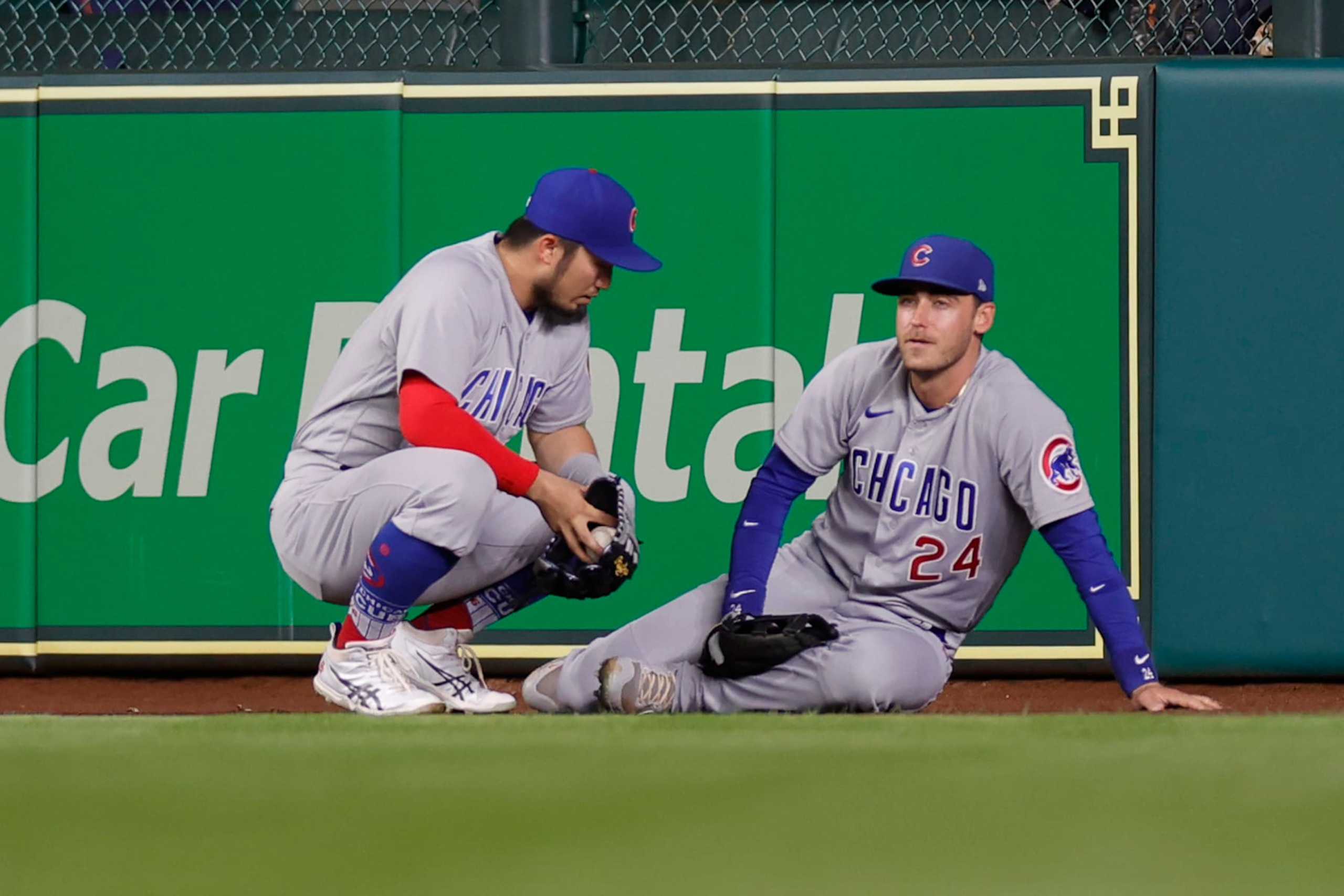 HOUSTON, TEXAS - MAY 15: Cody Bellinger #24 of the Chicago Cubs is joined by Seiya Suzuki #27  after being injured on a catch during the seventh inning against the Houston Astros at Minute Maid Park on May 15, 2023 in Houston, Texas. (Photo by Carmen Mandato/Getty Images)