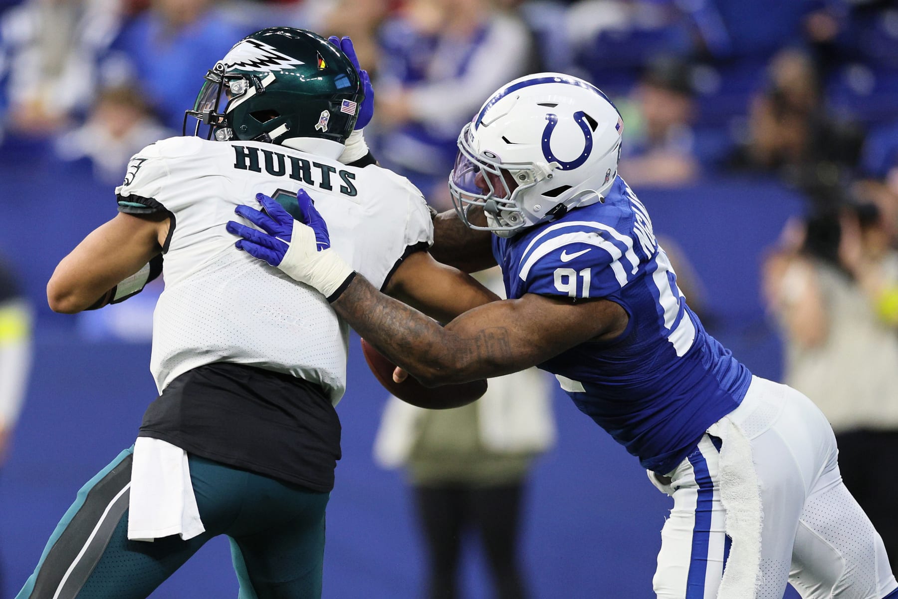 INDIANAPOLIS, INDIANA - NOVEMBER 20: Jalen Hurts #1 of the Philadelphia Eagles fumbles the ball after being hit by Yannick Ngakoue #91 of the Indianapolis Colts during the third quarter during the third quarter at Lucas Oil Stadium on November 20, 2022 in Indianapolis, Indiana. (Photo by Andy Lyons/Getty Images)