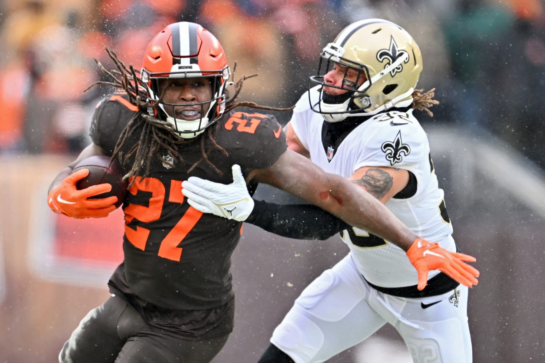 CLEVELAND, OHIO - DECEMBER 24: Kareem Hunt #27 of the Cleveland Browns is tackled by Tyrann Mathieu #32 of the New Orleans Saints during the first half at FirstEnergy Stadium on December 24, 2022 in Cleveland, Ohio. (Photo by Jason Miller/Getty Images)