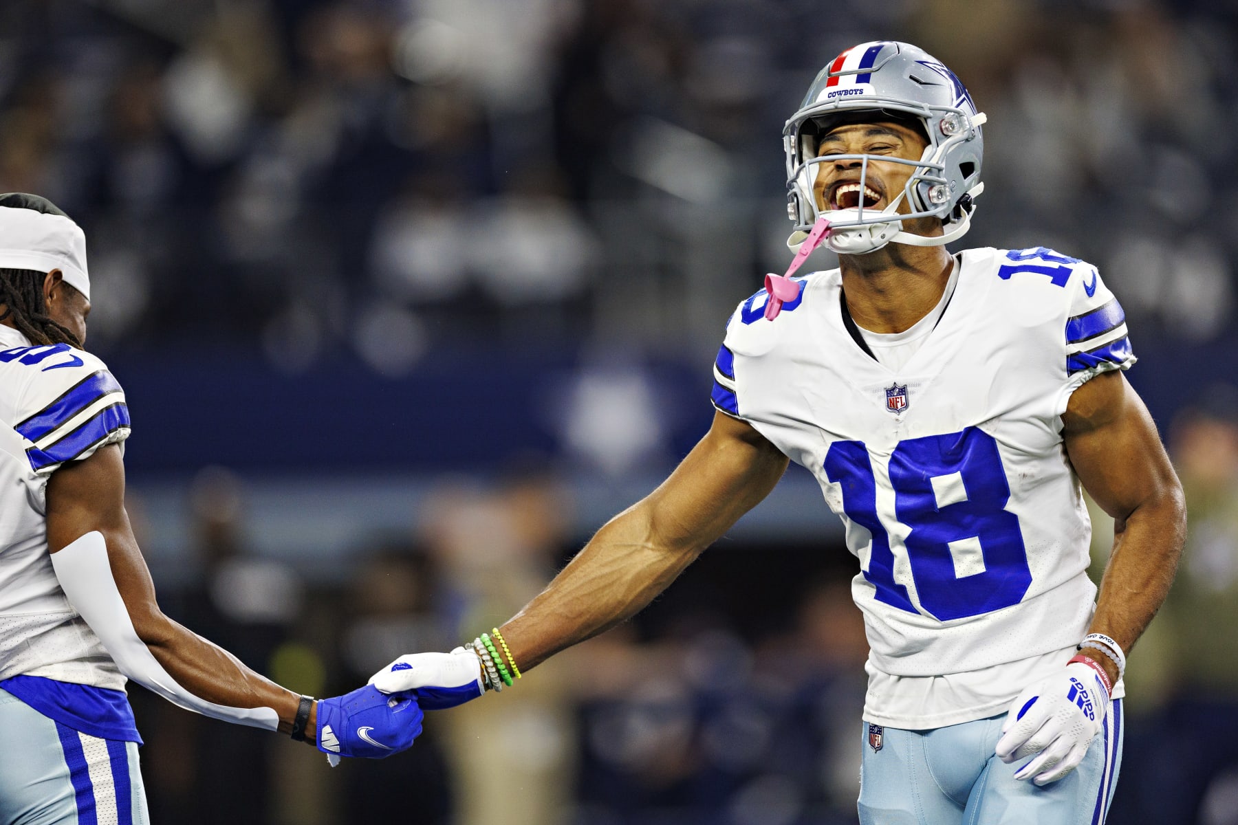 ARLINGTON, TEXAS - DECEMBER 4:  Jalen Tolbert #18 and KaVontae Turpin #9 of the Dallas Cowboys talk on the field before a game against the Indianapolis Colts at AT&T Stadium on December 4, 2022 in Arlington, Texas. The Cowboys defeated the Colts 54-19. (Photo by Wesley Hitt/Getty Images)