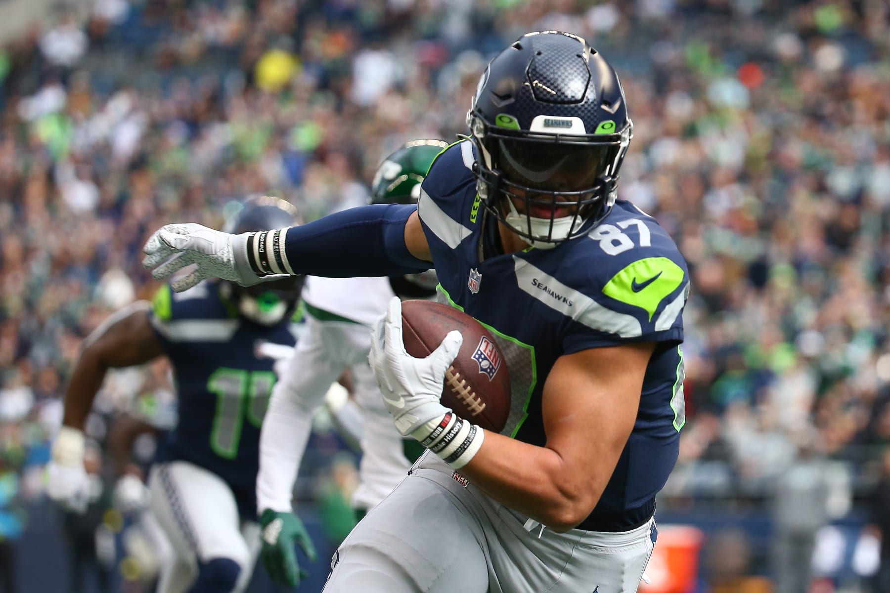 SEATTLE, WASHINGTON - JANUARY 01: Noah Fant #87 of the Seattle Seahawks runs the ball after a catch during the first quarter in the game against the New York Jets at Lumen Field on January 01, 2023 in Seattle, Washington. (Photo by Lindsey Wasson/Getty Images)