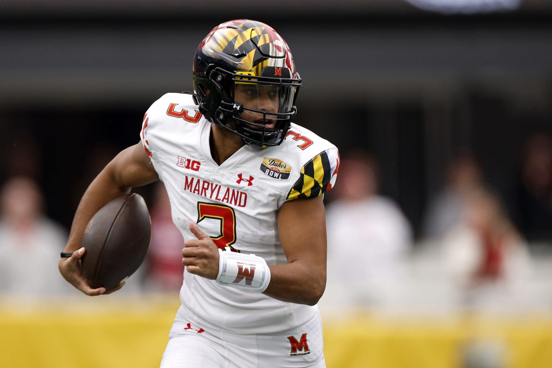 CHARLOTTE, NORTH CAROLINA - DECEMBER 30: Taulia Tagovailoa #3 of the Maryland Terrapins carries the ball for yardage during the first half of the Duke's Mayo Bowl against the North Carolina State Wolfpack at Bank of America Stadium on December 30, 2022 in Charlotte, North Carolina. (Photo by Jared C. Tilton/Getty Images)