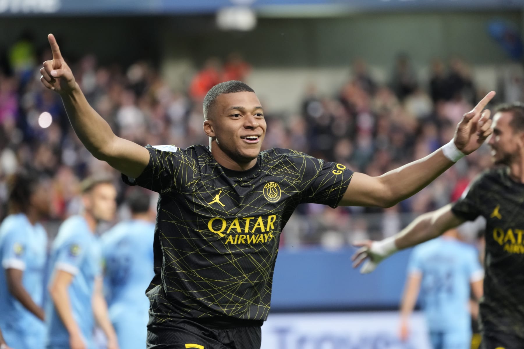 PSG's Kylian Mbappe celebrates after scoring his side's opening goal during the French League One soccer match between Troyes and Paris Saint Germain, at the Stade de l'Aube, in Troyes, France, Sunday, May 7, 2023. (AP Photo/Lewis Joly)