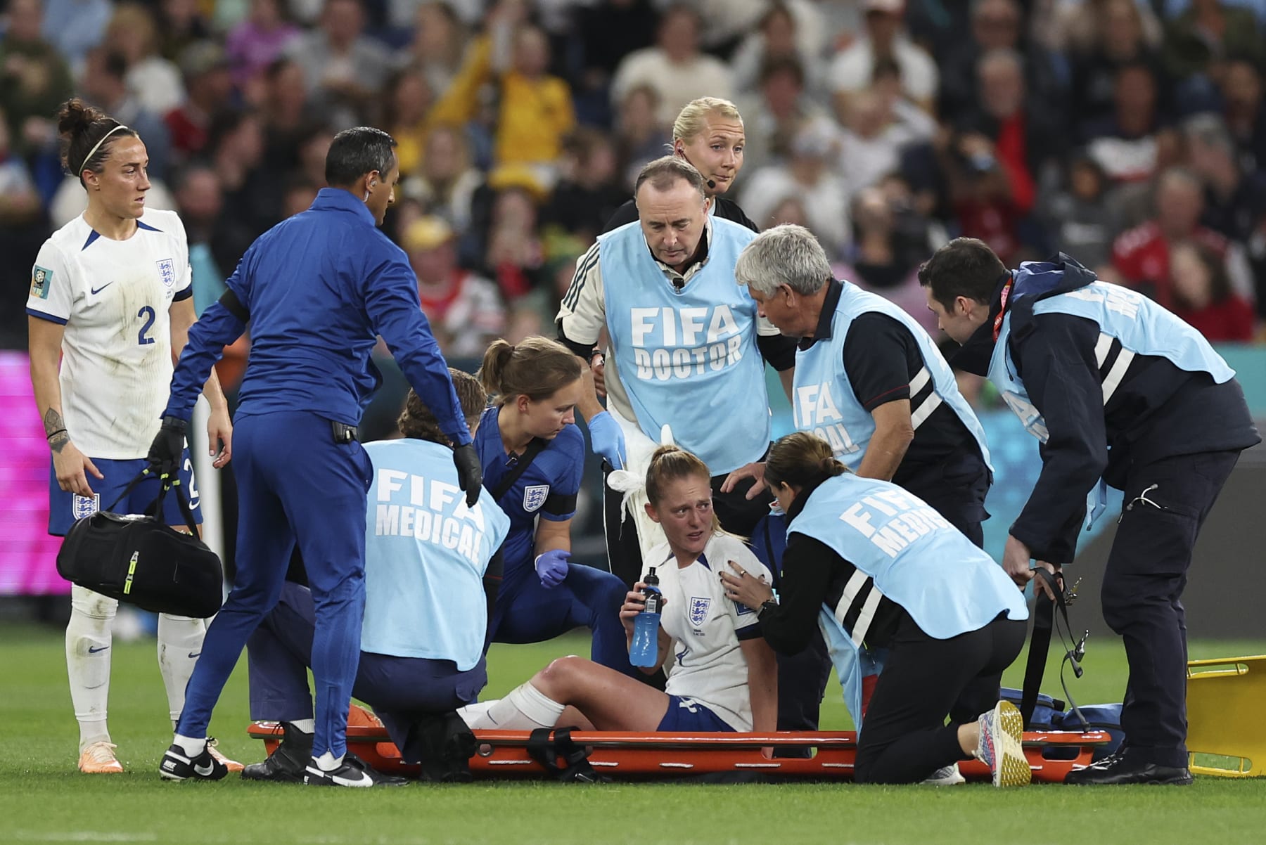 England's Keira Walsh talks with trainers before being carried off the pitch during the Women's World Cup Group D soccer match between England and Denmark at Sydney Football Stadium in Sydney, Australia, Friday, July 28, 2023. (AP Photo/Sophie Ralph)
