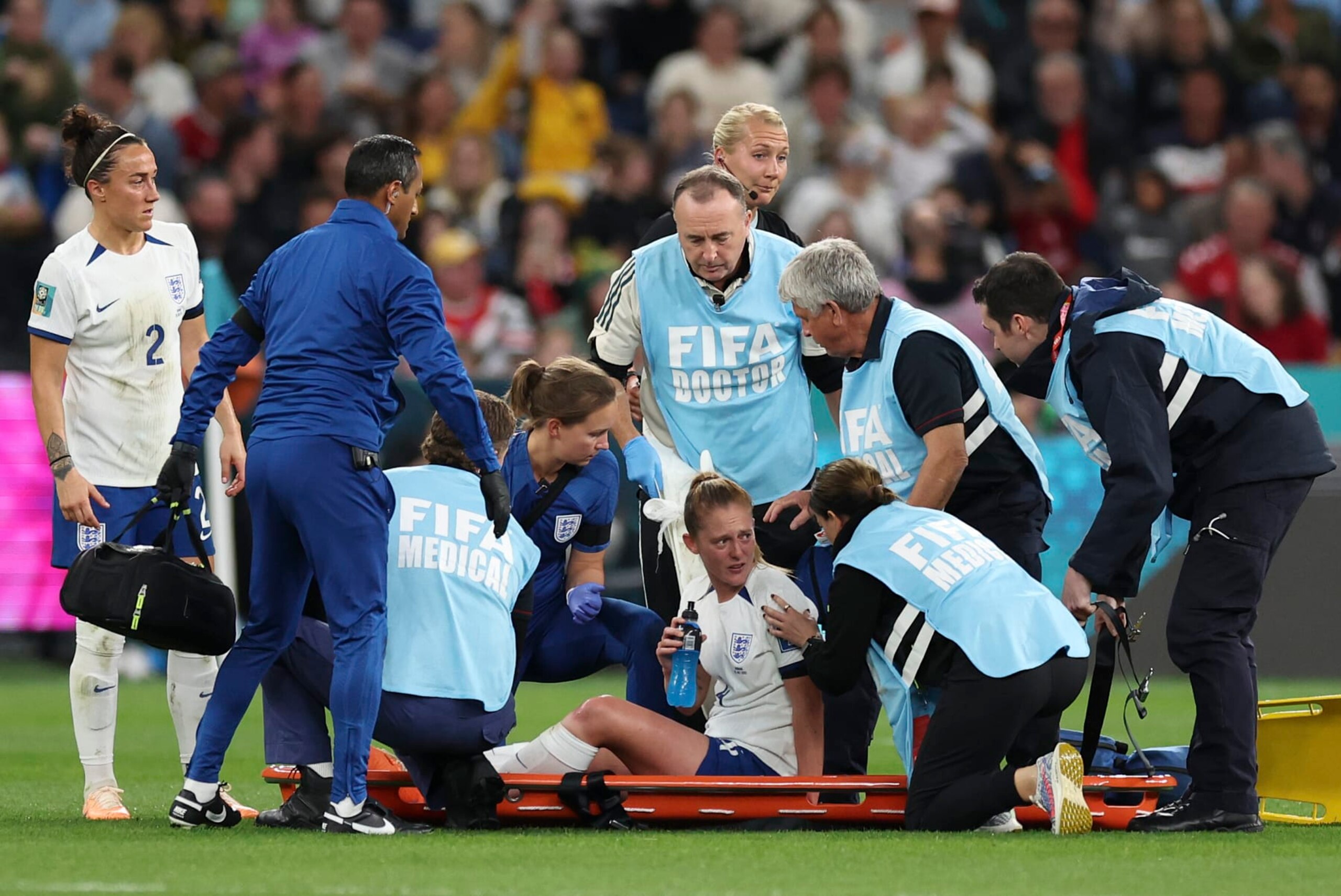 England's Keira Walsh talks with trainers before being carried off the pitch during the Women's World Cup Group D soccer match between England and Denmark at Sydney Football Stadium in Sydney, Australia, Friday, July 28, 2023. (AP Photo/Sophie Ralph)