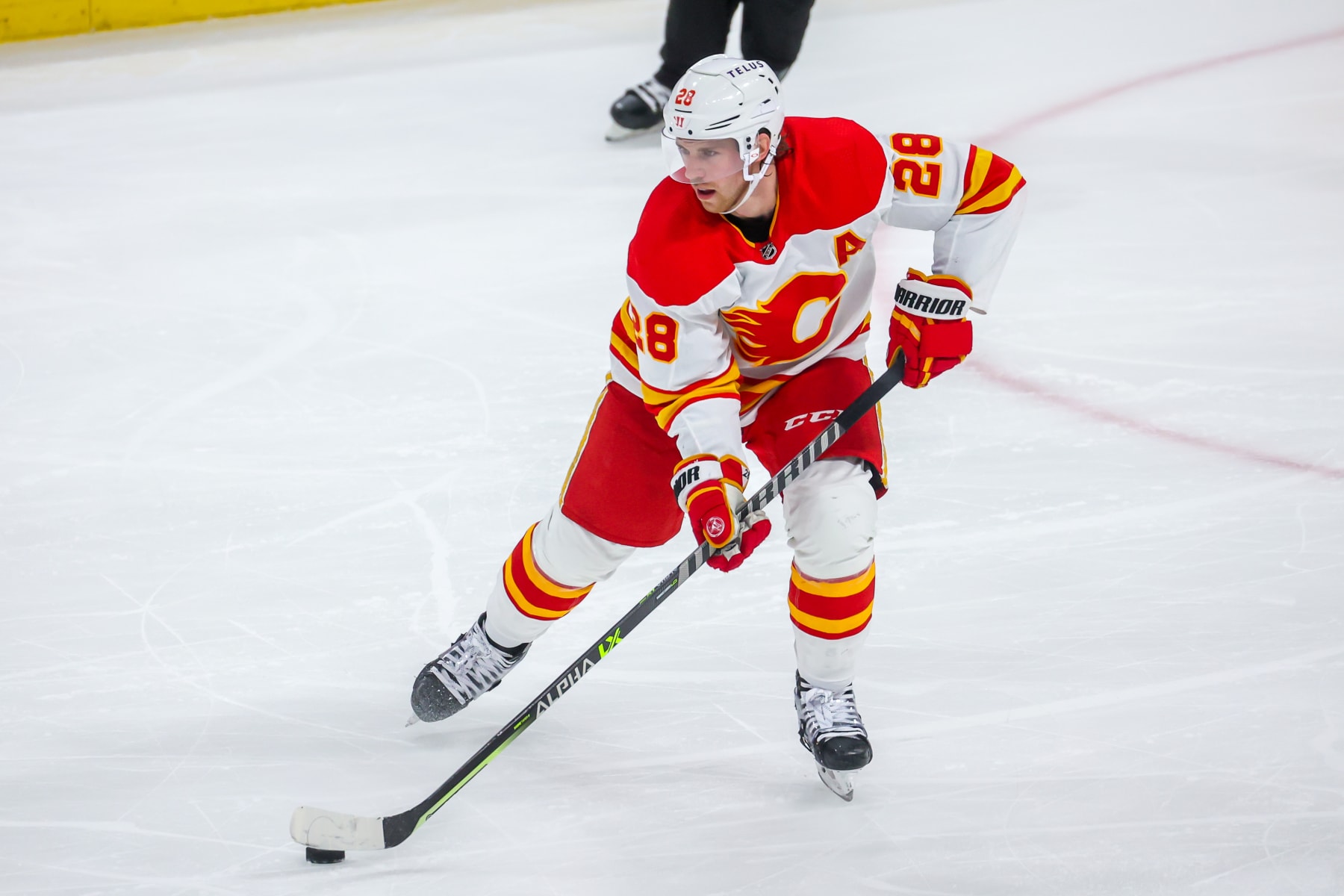 WINNIPEG, CANADA - APRIL 05: Elias Lindholm #28 of the Calgary Flames plays the puck during second period action against the Winnipeg Jets at Canada Life Centre on April 05, 2023 in Winnipeg, Manitoba, Canada. (Photo by Jonathan Kozub/NHLI via Getty Images)