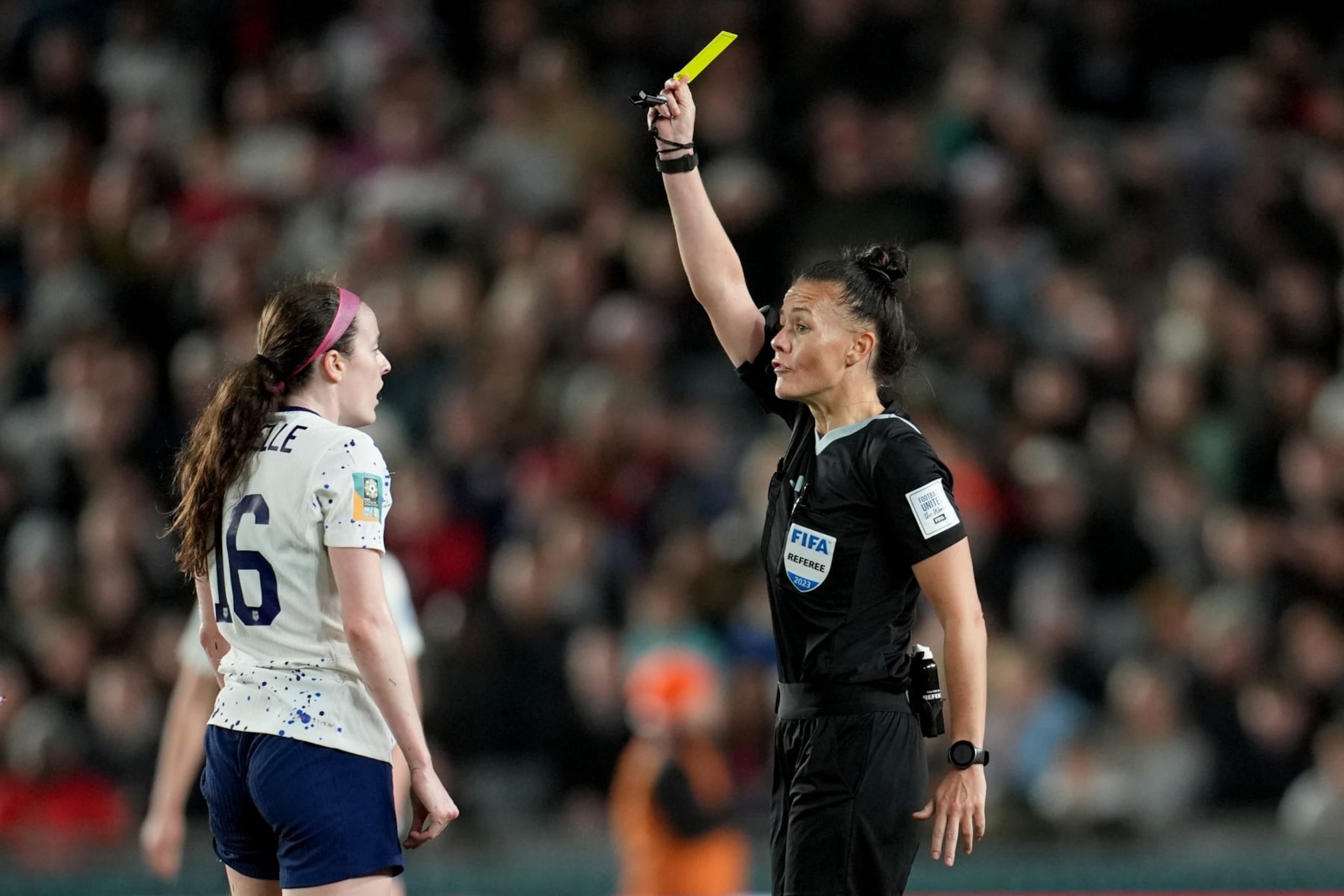 AUCKLAND, NEW ZEALAND - AUGUST 01: Referee Rebecca Welch gives a yellow card to Rose Lavelle #16 of the United States during the first half of the FIFA Women's World Cup Australia & New Zealand 2023 Group E match between Portugal and USA at Eden Park on August 01, 2023 in Auckland, New Zealand. (Photo by Brad Smith/USSF/Getty Images)