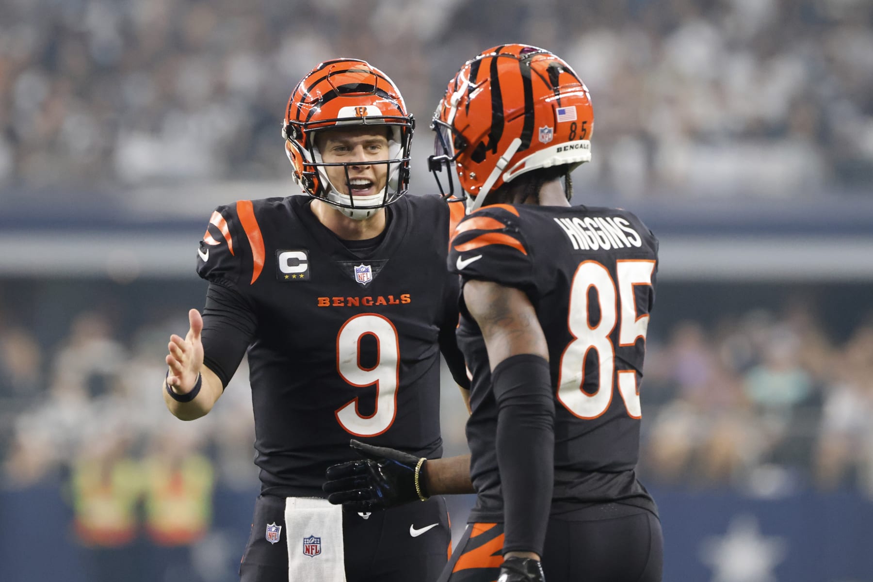 Cincinnati Bengals quarterback Joe Burrow (9) celebrates a first down with wide receiver Tee Higgins (85) during the second half of an NFL football game against the Dallas Cowboys Sunday, Sept. 18, 2022, in Arlington, Tx. (AP Photo/Michael Ainsworth)