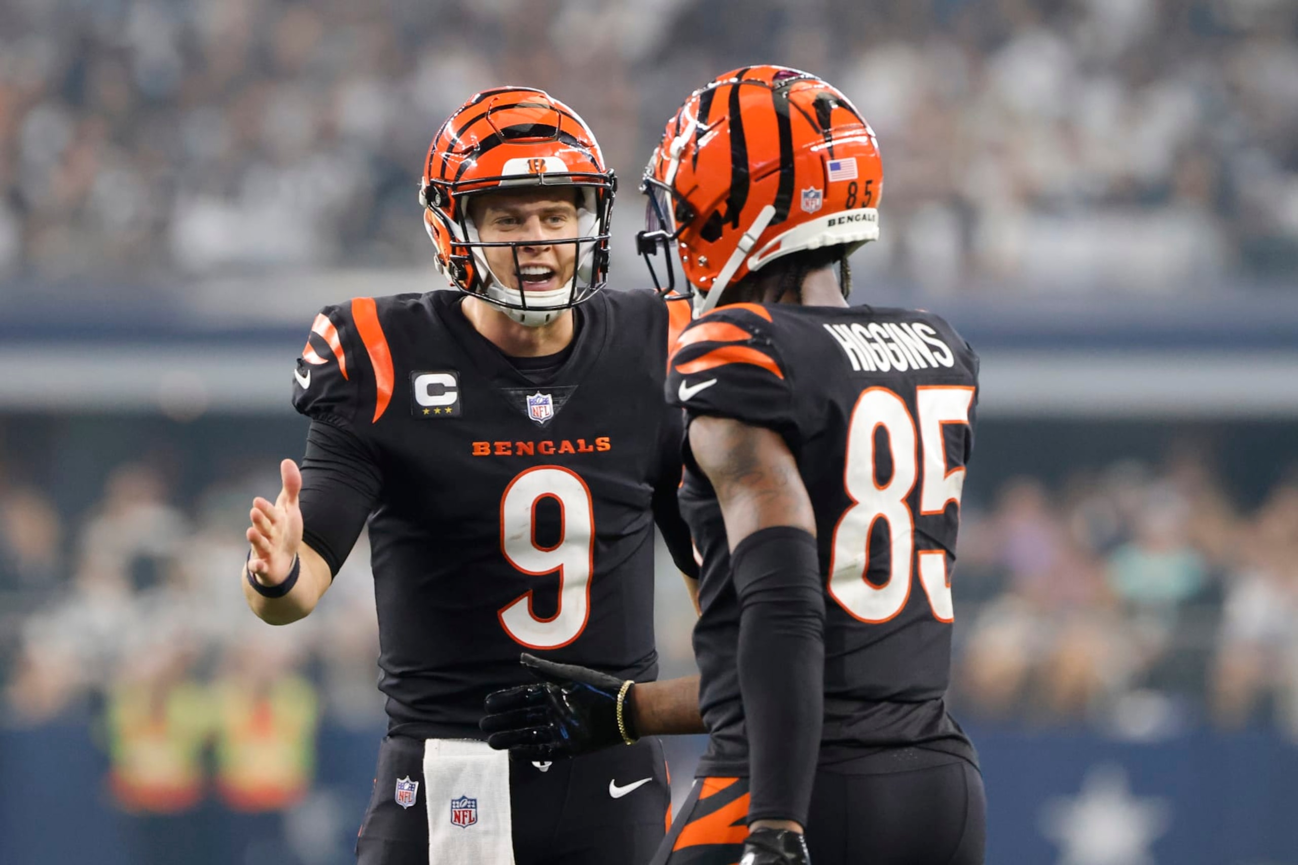 Cincinnati Bengals quarterback Joe Burrow (9) celebrates a first down with wide receiver Tee Higgins (85) during the second half of an NFL football game against the Dallas Cowboys Sunday, Sept. 18, 2022, in Arlington, Tx. (AP Photo/Michael Ainsworth)