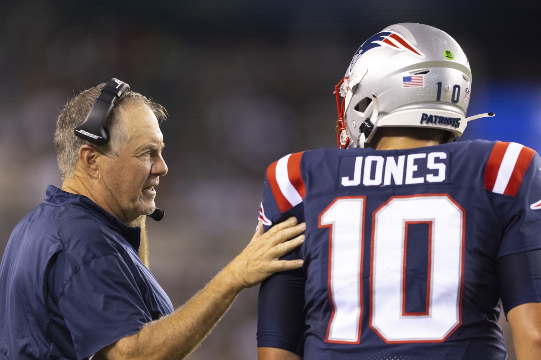 PHILADELPHIA, PA - AUGUST 19: Head coach Bill Belichick of the New England Patriots talks to Mac Jones #10 against the Philadelphia Eagles in the first half of the preseason game at Lincoln Financial Field on August 19, 2021 in Philadelphia, Pennsylvania. The Patriots defeated the Eagles 35-0. (Photo by Mitchell Leff/Getty Images)